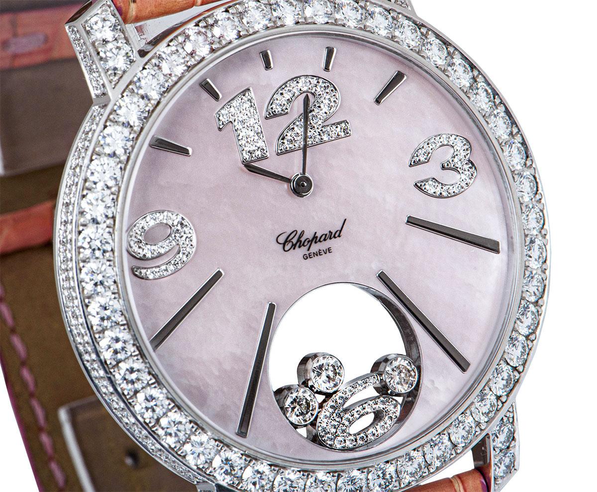 An 18k White Gold Happy Diamonds Ladies Wristwatch, pink mother of pearl dial with applied hour markers, applied arabic numbers 3, 9 and 12 set with round brilliant cut diamonds, floating arabic number 6 and 3 floating round brilliant cut diamonds