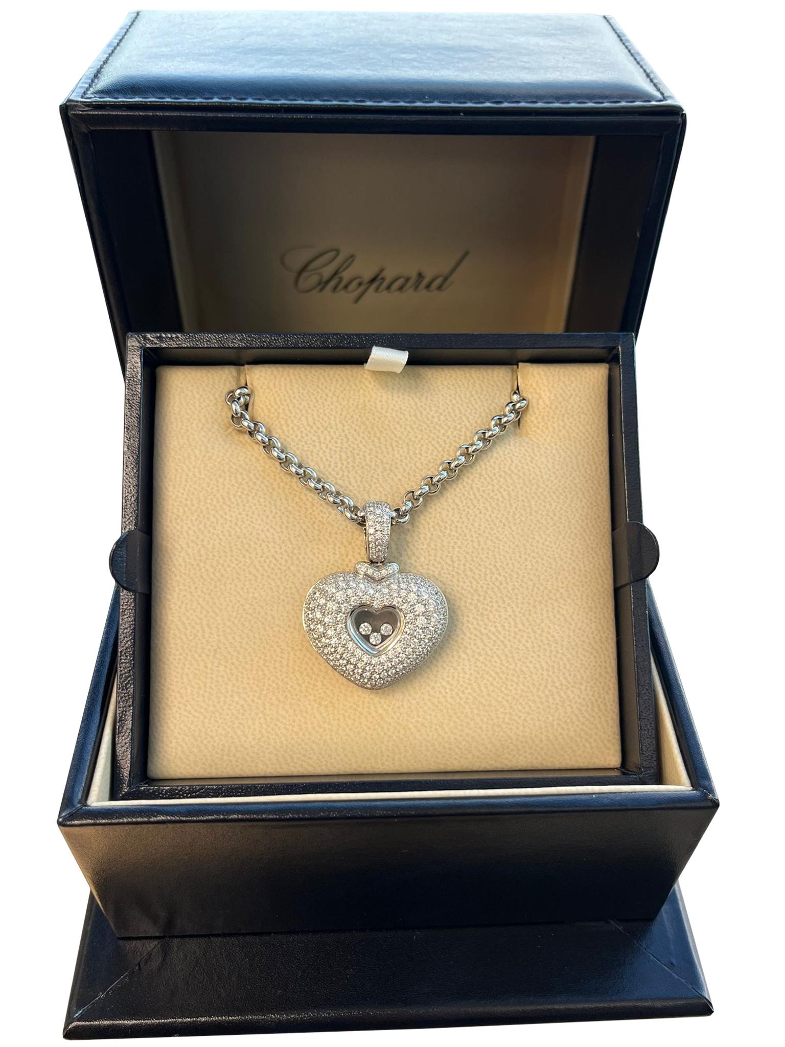 This stunning Chopard necklace is an exquisite piece from the Happy Hearts Diamonds collection, known for its exceptional craftsmanship and luxurious design. Featuring a very large pendant adorned with original Chopard diamonds, totaling an