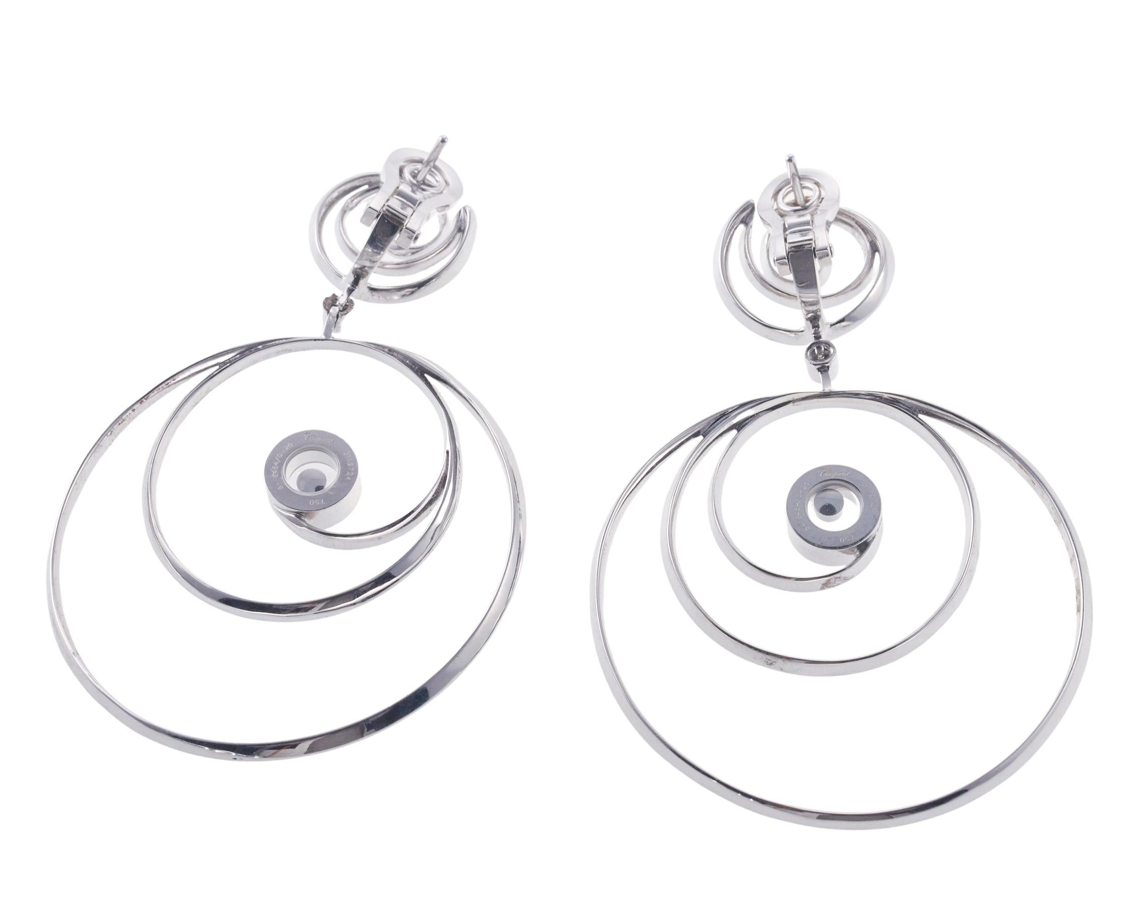 Pair of 18k white gold drop earrings by Chopard for Happy Diamonds collection, set with approx. 1.75ctw in VVS/F-G diamonds. Earrings measure 63mm x 43mm. Marked: Chopards, 750, Serial Number. Weight is 22.2 grams.
