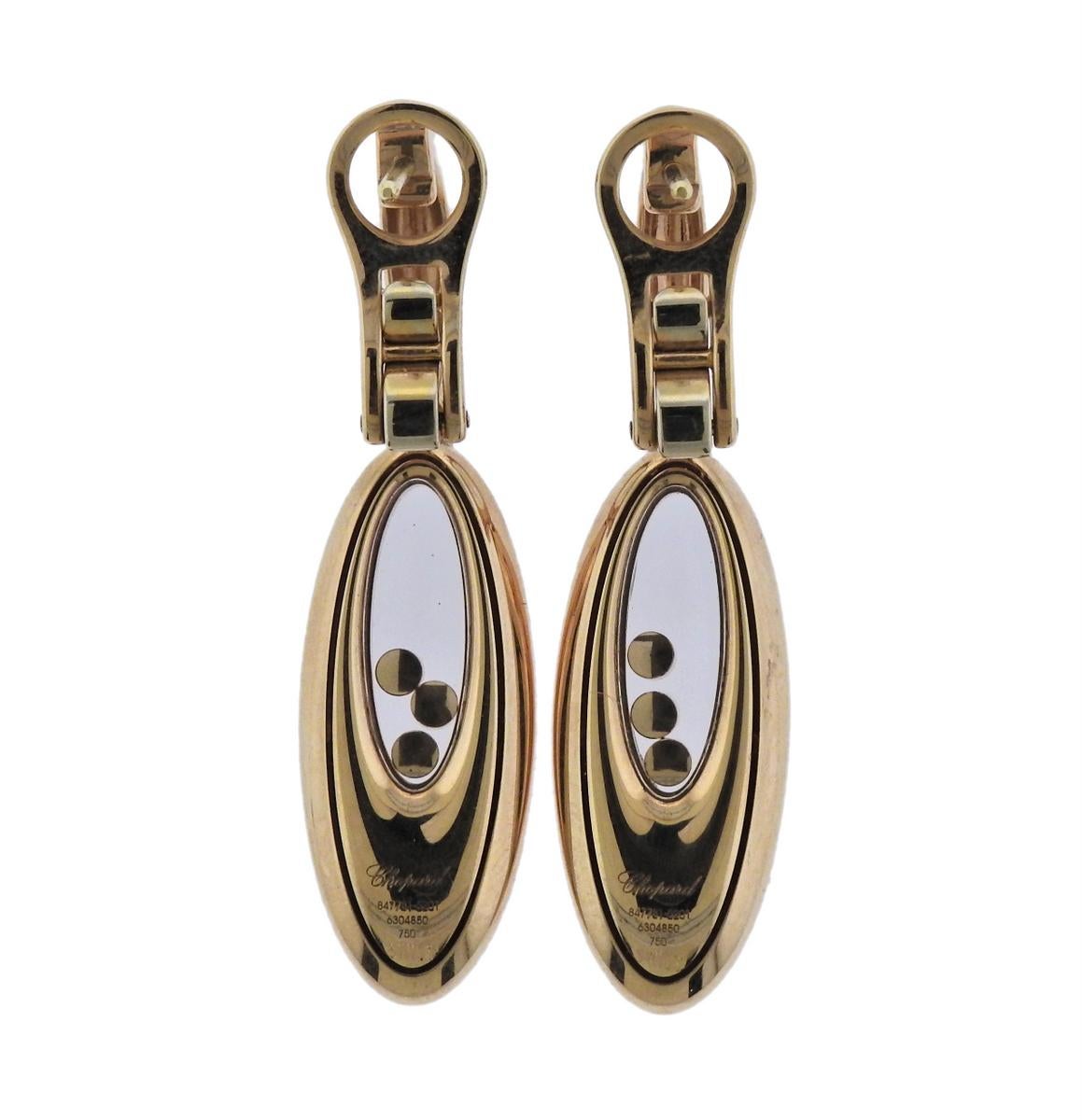  18k gold drop earrings, crafted by Chopard for Happy Diamonds collection, featuring iconic floating diamonds in the center (approx. 0.18ctw). Retail $7070. Earrings are 43mm x 11mm, weigh 20 grams. Marked: Chopard, 750, 847781-5201, 6304850, Swiss.