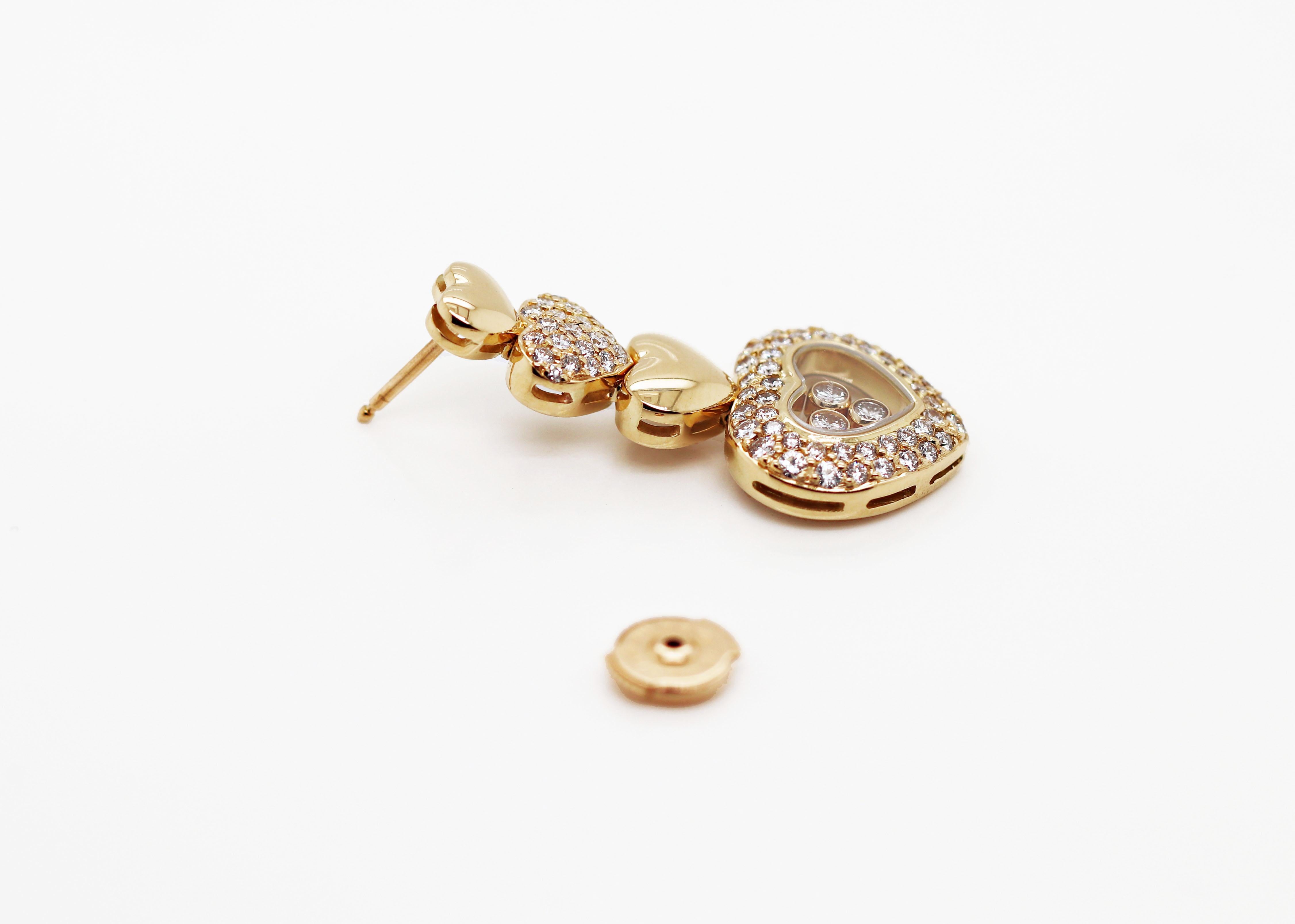 18 carat yellow gold Chopard earrings from the famous Happy Diamonds Collection featuring four graduating hearts pavé set with 66 fine quality round brilliant cut diamonds weighing a total of 1.30ct in each earring. The largest heart features a
