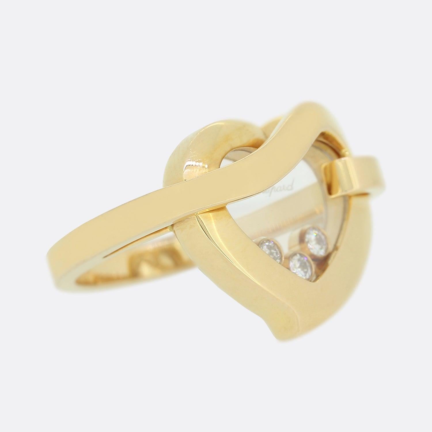 This is an 18ct rose gold ring from Chopard's 'Happy Diamonds' collection. The ring features a heart shaped face with 3, crystal encased, floating diamonds in the centre.

Condition: Used (Very Good)
Weight: 10.8 grams
Size: M (53)
Face Dimensions: