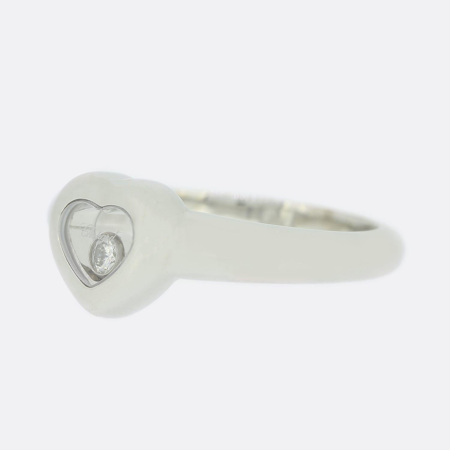 This is an 18ct white gold ring from Chopard's 'Happy Diamonds' collection. The ring features a heart shaped centre piece with 1 central floating diamond encased inside. This is a highly recognisable iconic Chopard style.

Condition: Used