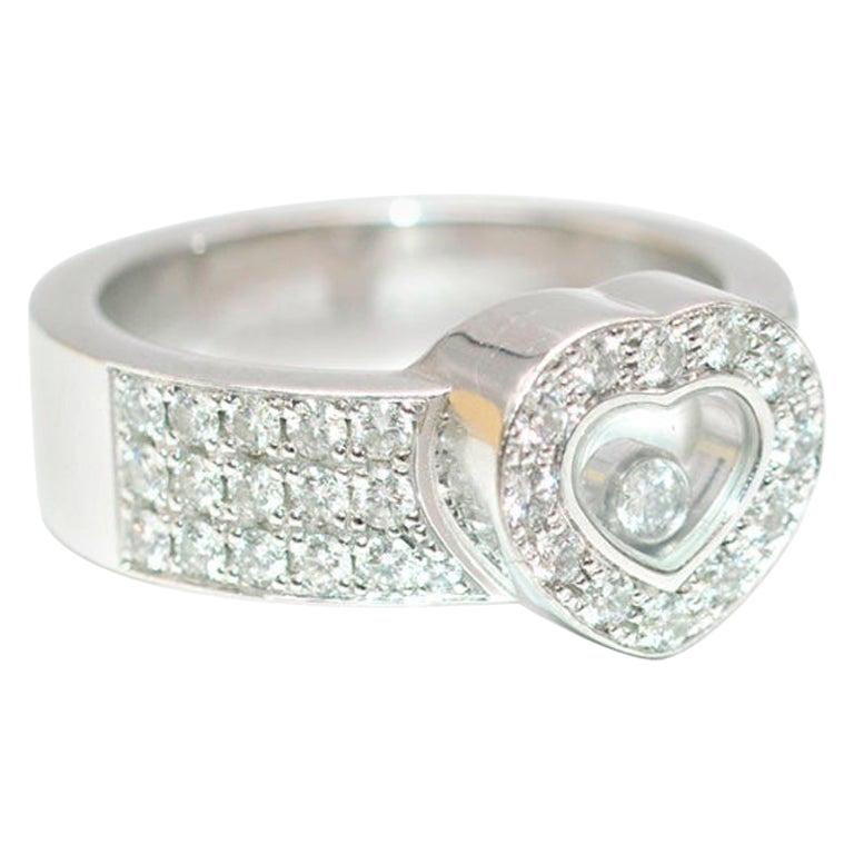 Chopard - Happy diamonds heart ring 

18k white gold - pave diamonds across the band and heart - heart shape with single floating diamond - Carat total is 0.74

Please note, these items are pre-owned and may show signs of being stored even when