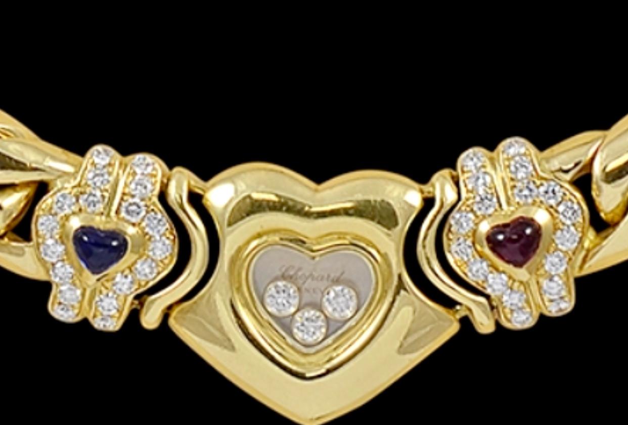 18 Karat Yellow Gold Happy Diamonds Heart Necklace with one ruby and one sapphire
by Chopard. 
It is 16 inch long 

Weight: 99 grams
Stamped French Hallmarks: 750 ,1187, Chopard Geneve
Chopard Geneve inscribed on the heart shape glass.

Please look