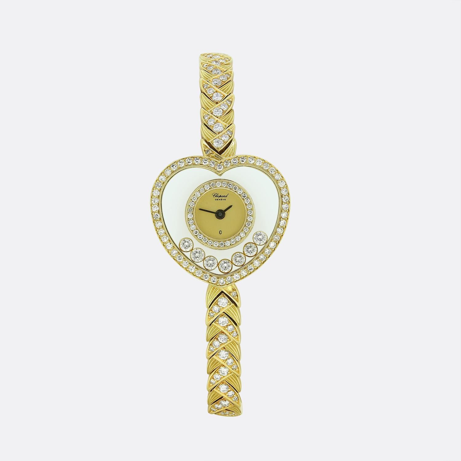 Here we have a fabulous diamond cocktail watch from the world renowned French jewellery designer, Chopard. This 'Happy Diamonds' piece has been crafted from a rich 18ct yellow gold and features a champagne dial with a distinctive bezel shaped like a