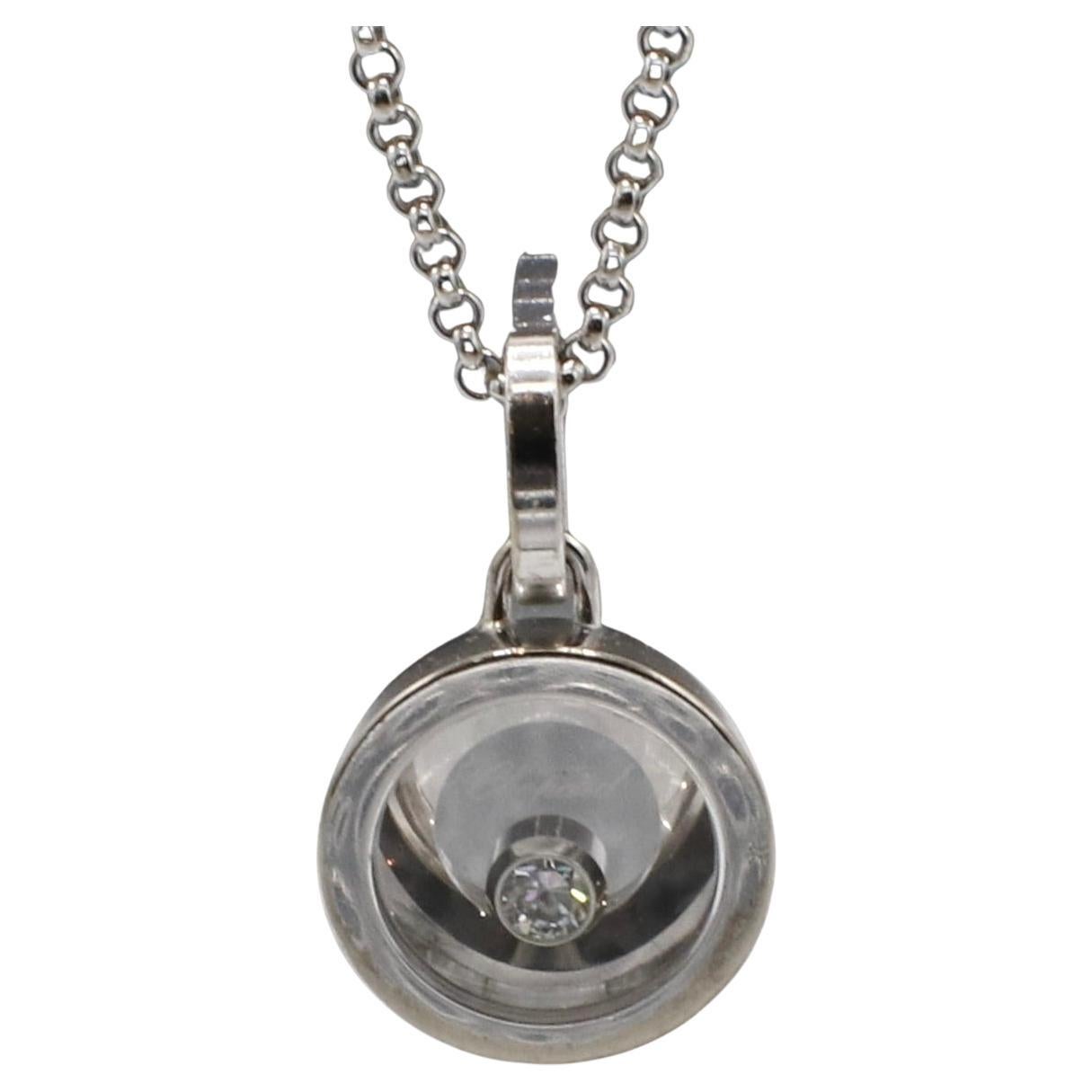 Chopard Happy Diamonds Icon 18 Karat White Gold Floating Circle Disc Pendant Necklace 
Metal: 18k white gold
Weight: 11.31 grams
Pendant: 13mm
Length: 16 inches
Diamond: 1 round natural diamond 0.05 carat F VVS
Retail: $2,450 USD
ODD F35001012
