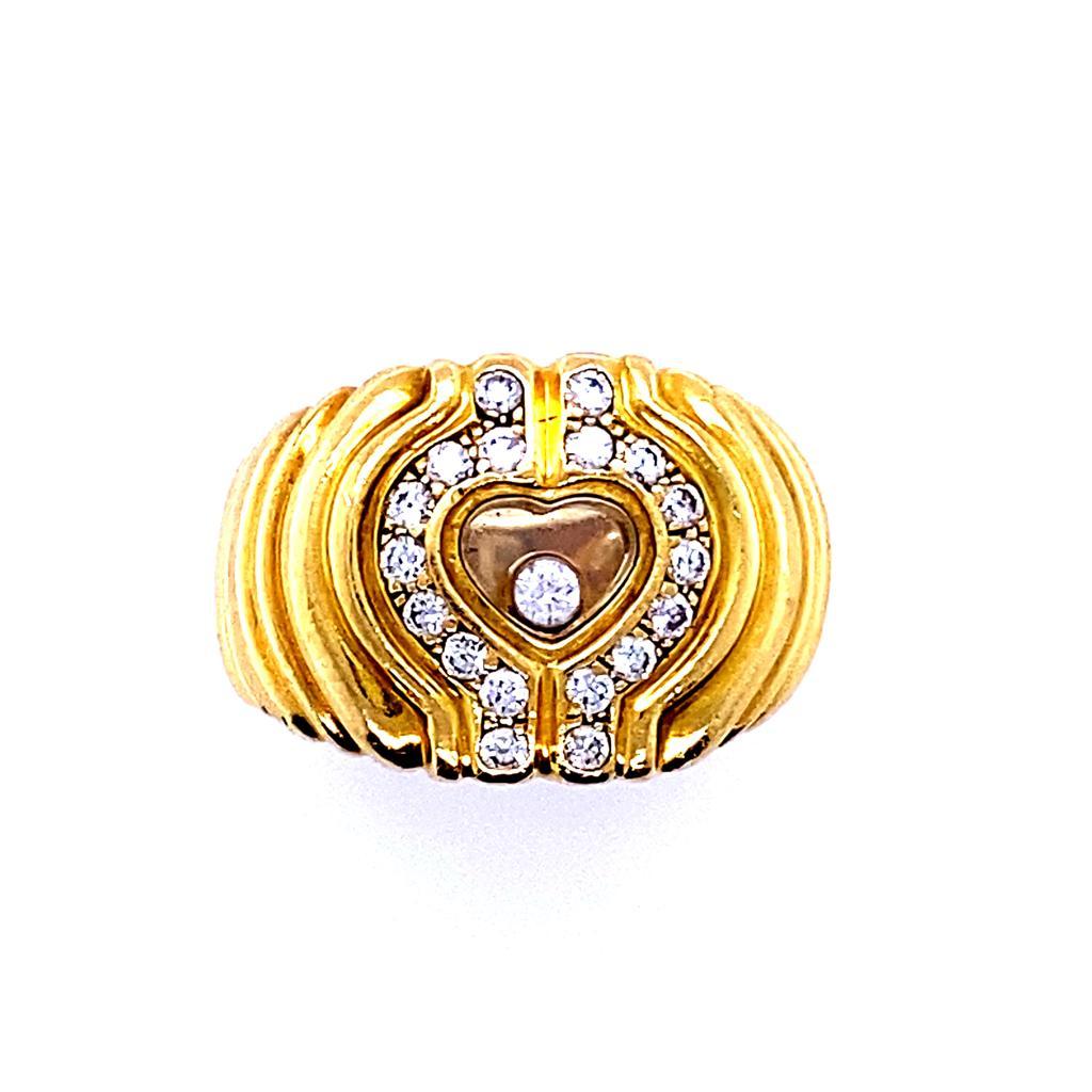 A Chopard Happy Diamonds Icons heart 18 karat yellow gold ring, circa 2000.

This bold and chunky heart shaped ring is from Chopard's signature Happy Diamond collection.

The ring contains one of Chopard's iconic floating diamonds set within a fine