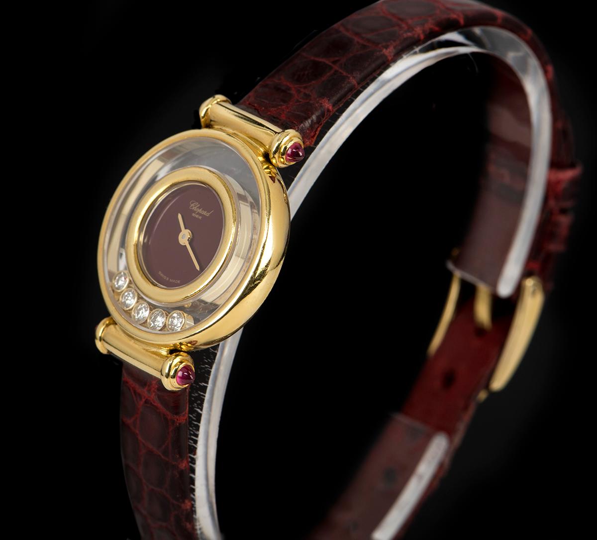 An 18k Yellow Gold Happy Diamonds Ladies Wristwatch, maroon dial, a fixed 18k yellow gold inner bezel, a fixed 18k yellow gold outer bezel, 5 round brilliant floating diamonds in between both bezels, a maroon leather strap (not by Chopard) with an