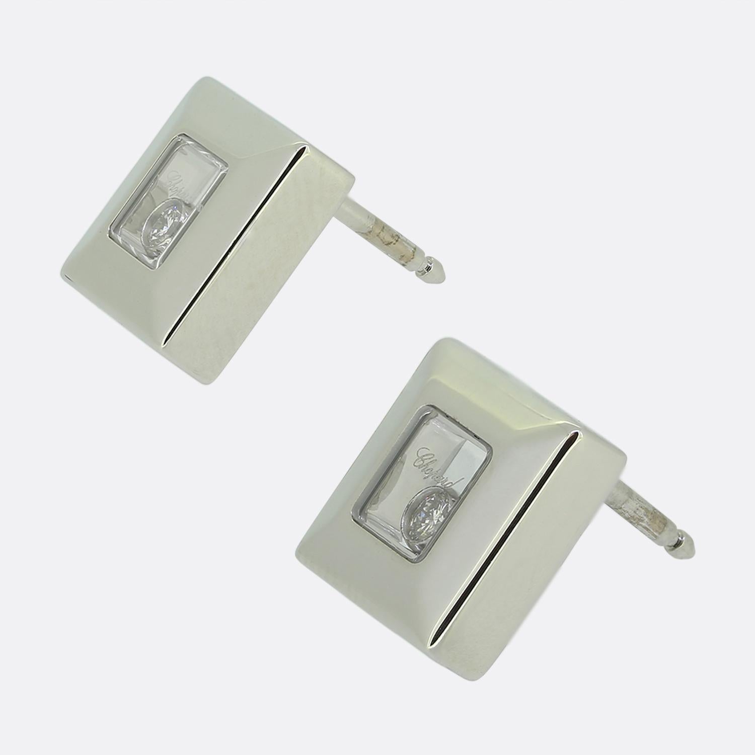 Here we a pair of 18ct white gold earrings from Chopard's 'Happy Diamonds' collection. Each identical piece has been crafted into the shape of a square with a plain polished frame playing host to a single floating round brilliant cut diamond encased