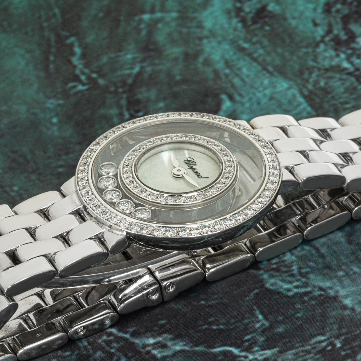 A white gold diamond-set timepiece by Chopard from their Happy Diamonds collection. Featuring a mother of pearl dial surrounded by approximately 34 round brilliant-cut diamonds set within the inner bezel. Further complementing the watch are 5 round