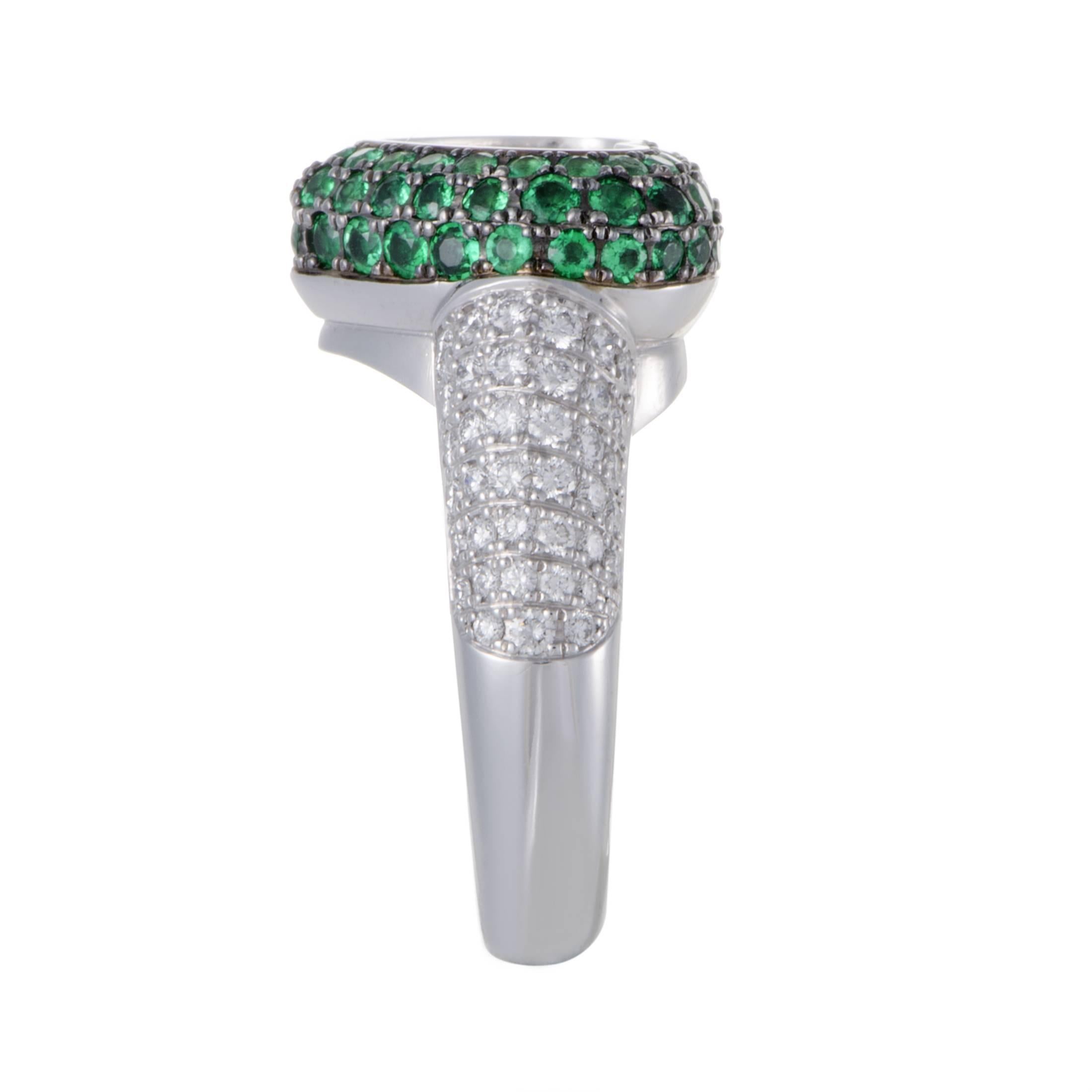 Lavishly embellished with a precious blend of emeralds weighing in total 1.40 carats and resplendent diamonds amounting to 0.79ct, this majestic heart-shaped 18K white gold ring form Chopard is a brilliantly designed and expertly crafted item that