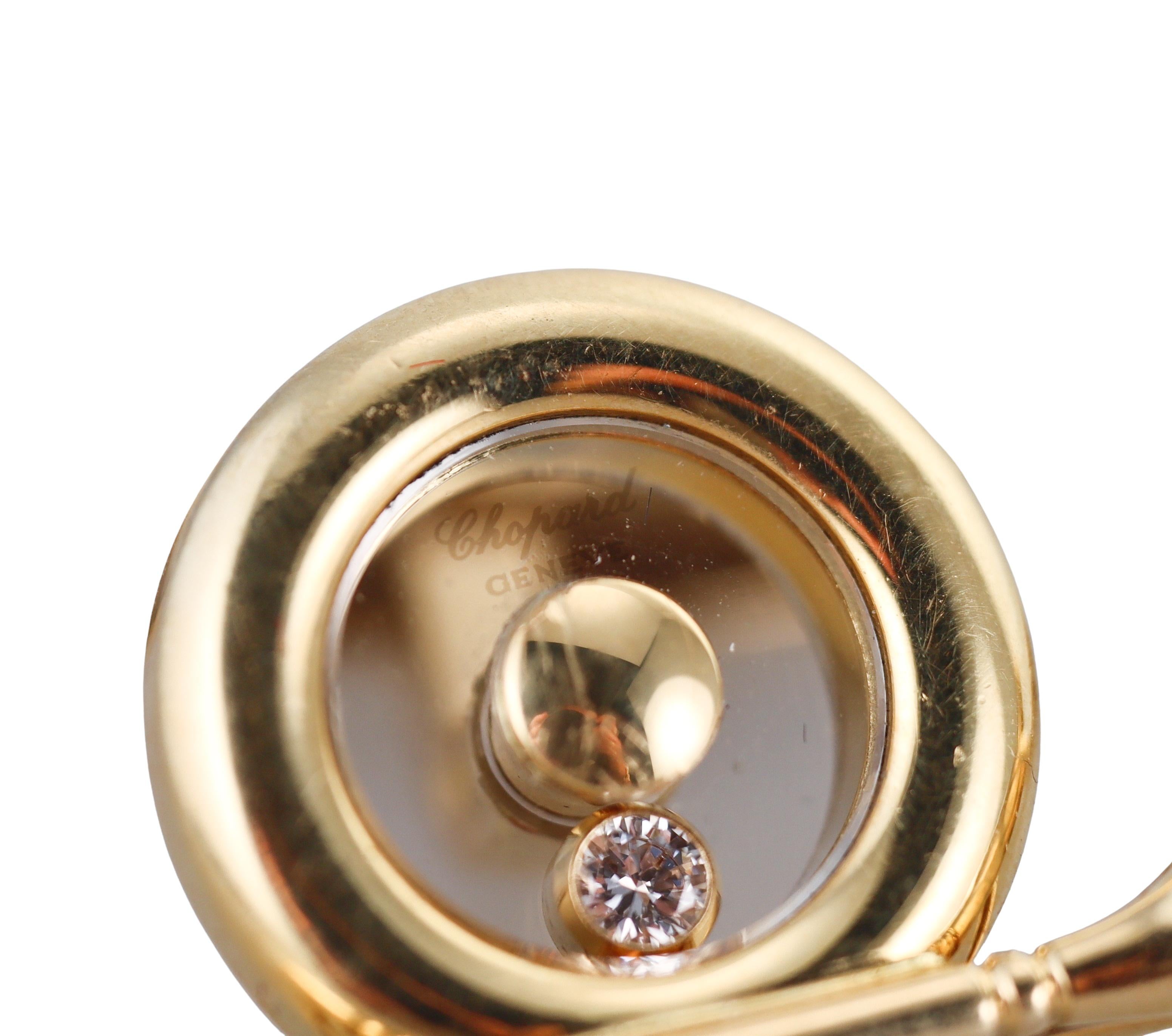 A pair of 18k yellow gold cufflinks by Chopard, from signature Happy Diamonds collection, each featuring iconic floating diamond inside (approx. 0.03ct each FG/VVS). Depicting a golf club. 
Each cufflink measures 25mm x 15mm.
Marked: Chopard, 3026,
