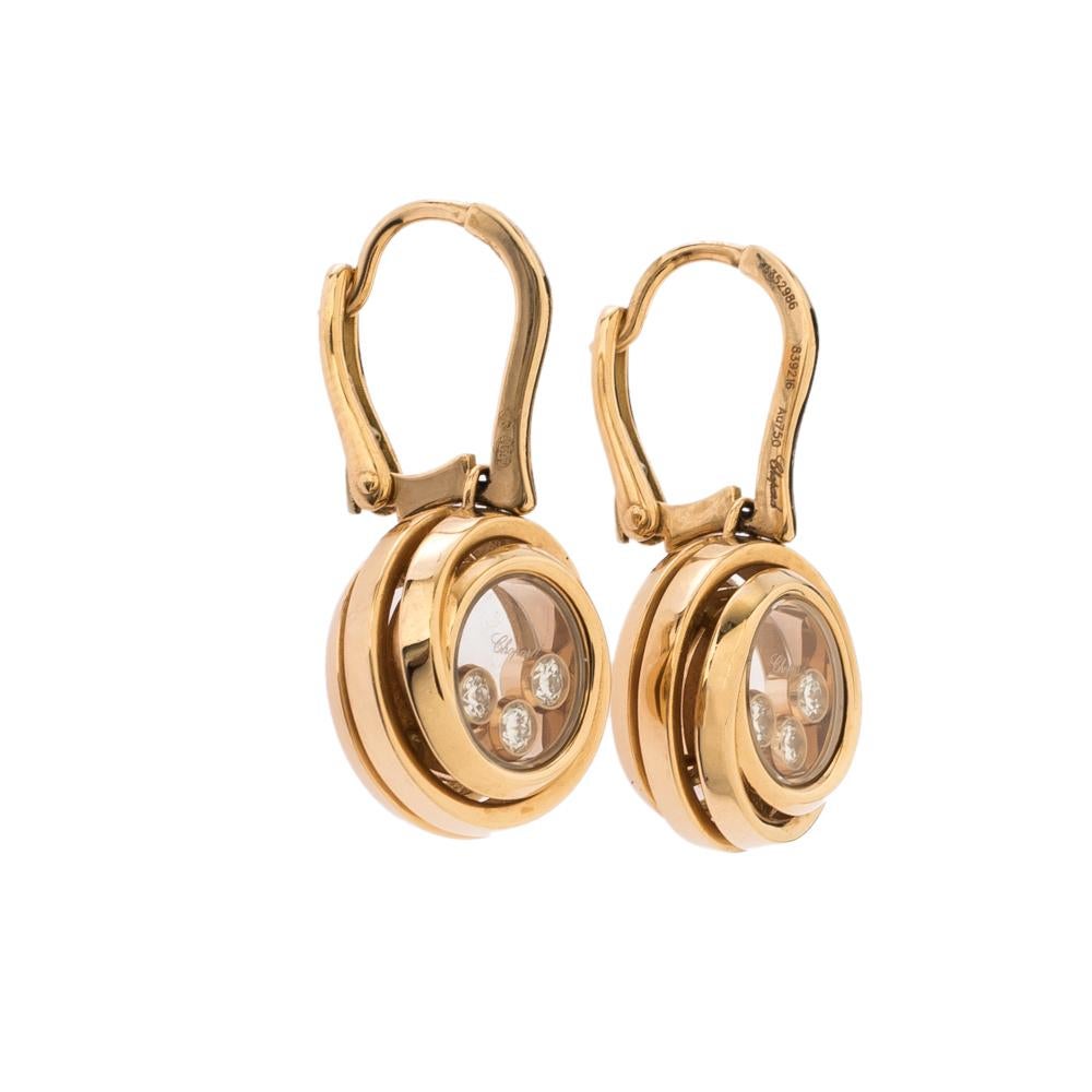 These Chopard earrings come to life in 18k rose gold. Enchanting circles attached to closures are given a spiral touch while three dancing diamonds are trapped inside each ring. The pair is a creation of beauty that sparkles like morning