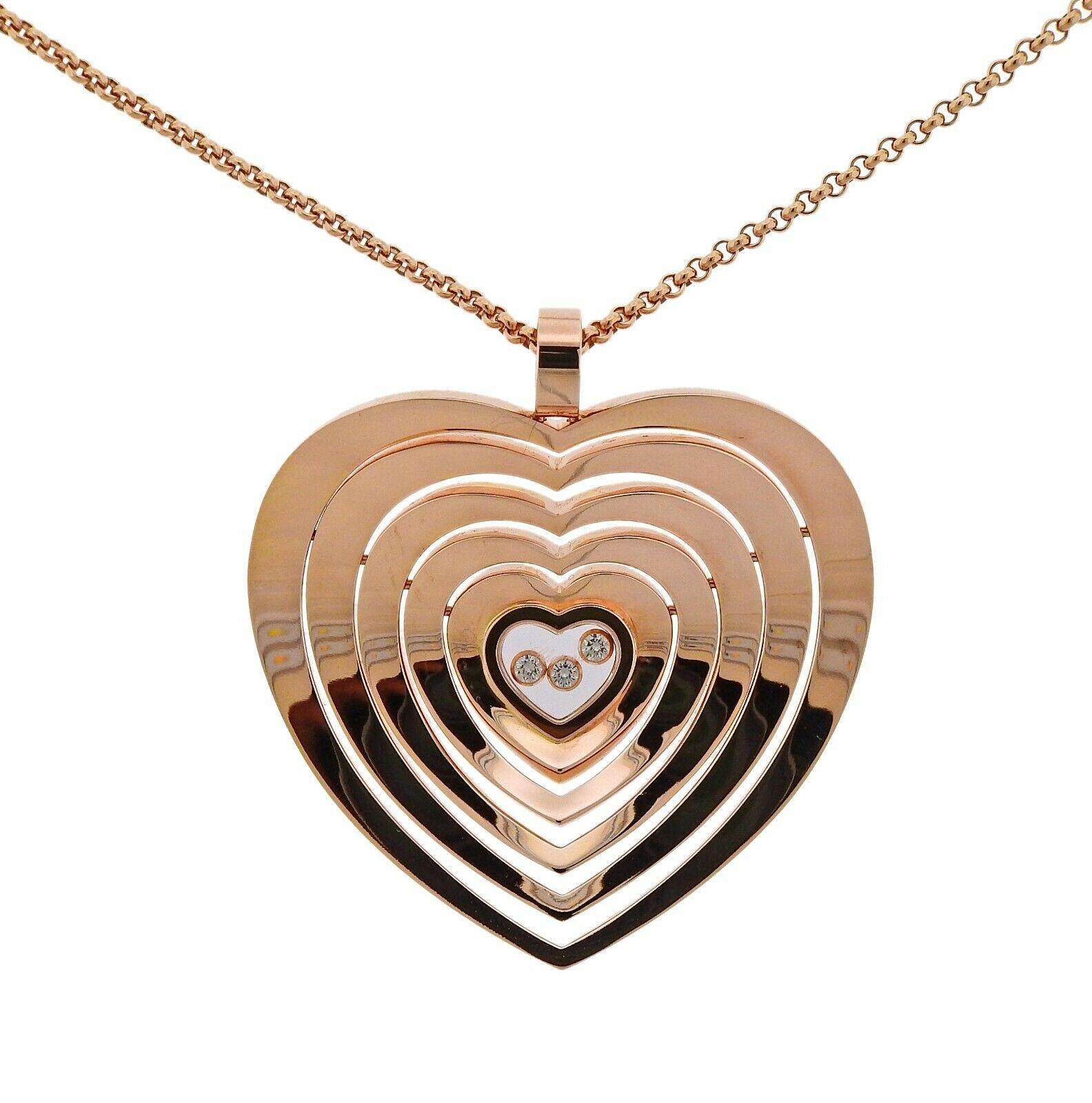 Chopard Happy Heart pendant necklace, featuring approx. 0.15ctw FG/VVS floating diamonds and movable pendant elements. Necklace is 24