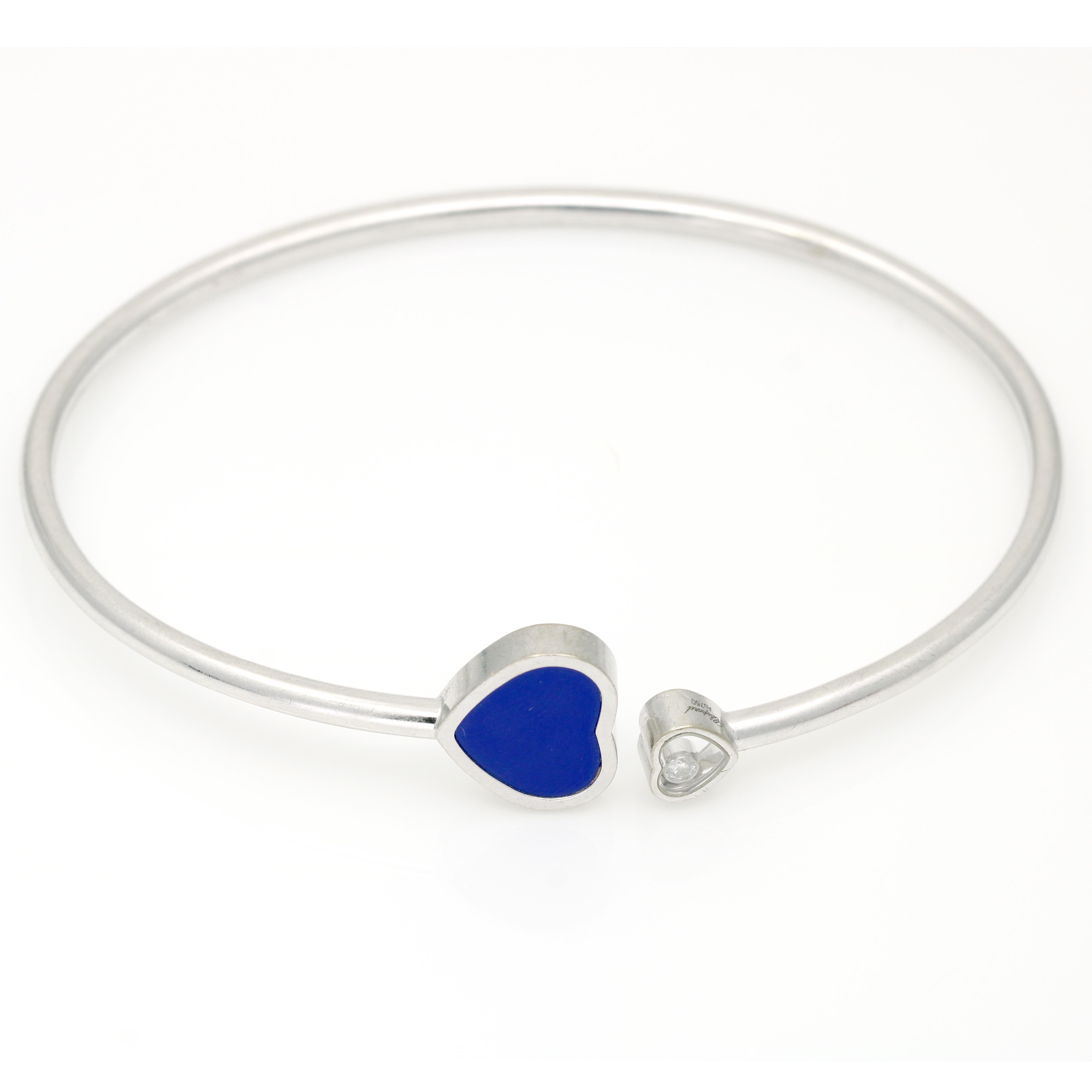 Embrace elegance and emotion with the Chopard Happy Hearts Bangle Bracelet, a captivating expression of love and luxury. This exquisite bracelet features the iconic Happy Hearts design, adorned with a delicate floating diamond and captivating Lapis