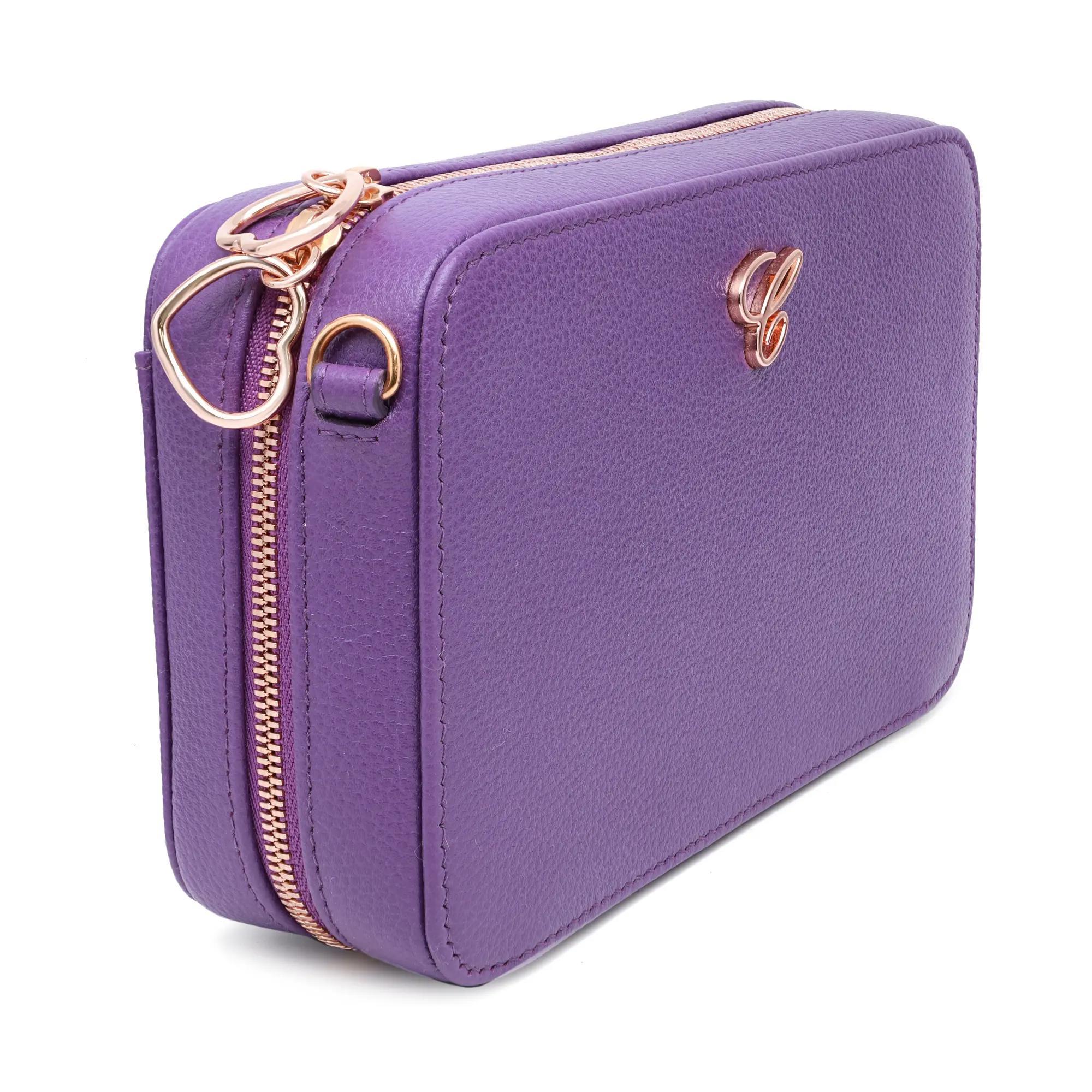The Chopard Happy Hearts Purple Grained Leather Camera Bag is a compact and stylish accessory featuring a top heart shape zipper closure for secure storage. Made from purple leather, it showcases grained patterns with the Chopard logo monogram in
