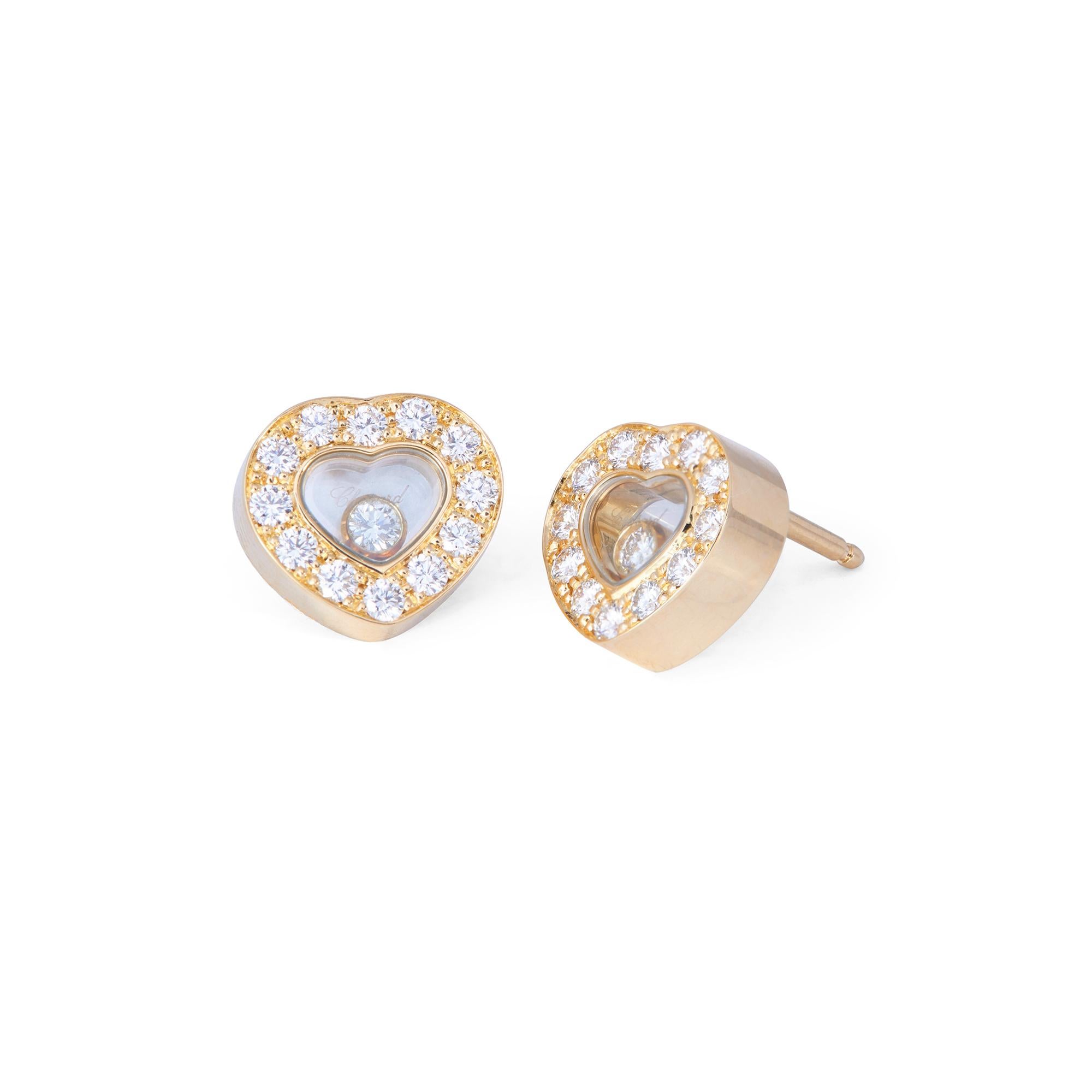 Authentic Chopard Happy Hearts earrings crafted in 18 karat yellow gold.  Each earring features Chopard's signature floating diamond surrounded by a frame of pave set round brilliant cut diamonds for an estimated 0.65 carats total weight. Signed