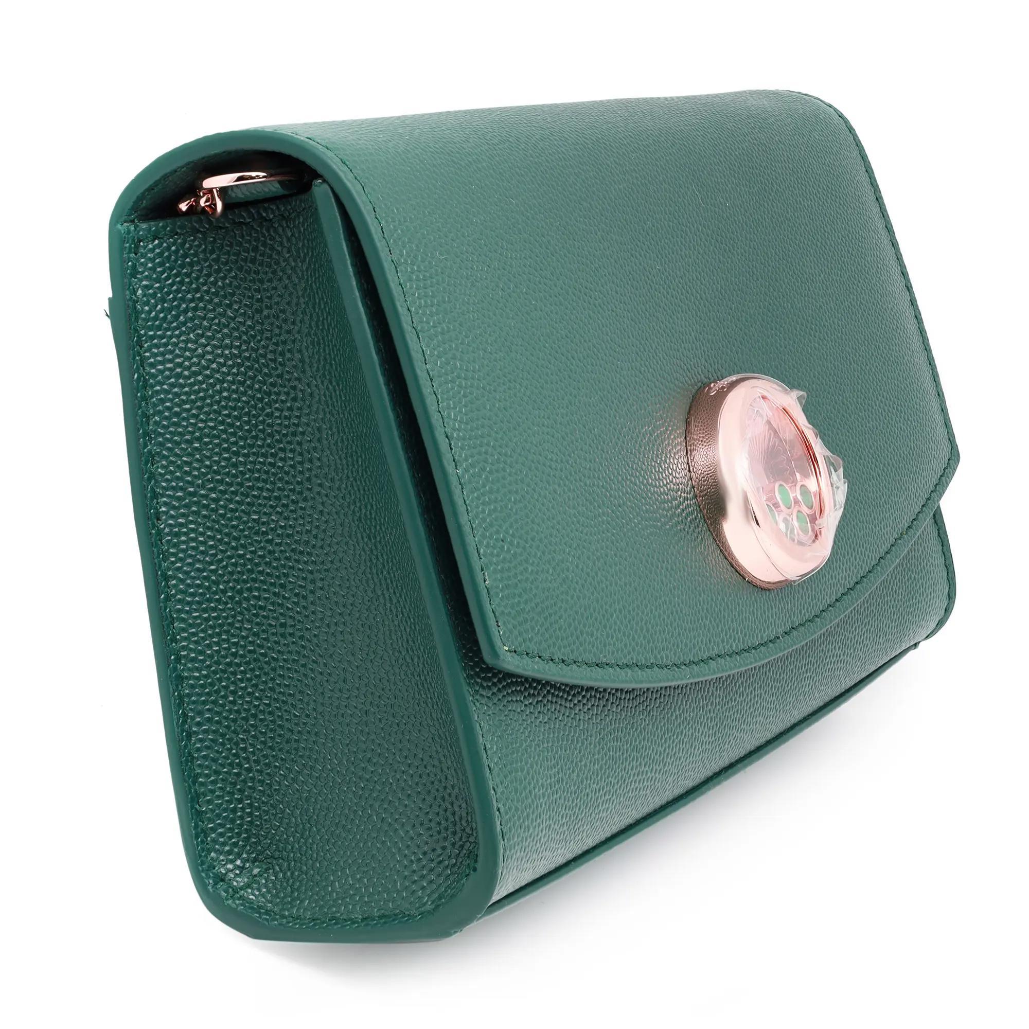 Chic and stylish, this green grained calf leather handbag allows freedom of movement thanks to its adjustable shoulder strap. Showcases a circular motif with magnetic closure in the front, embellished with 5 moving round bezel set Malachite stones.