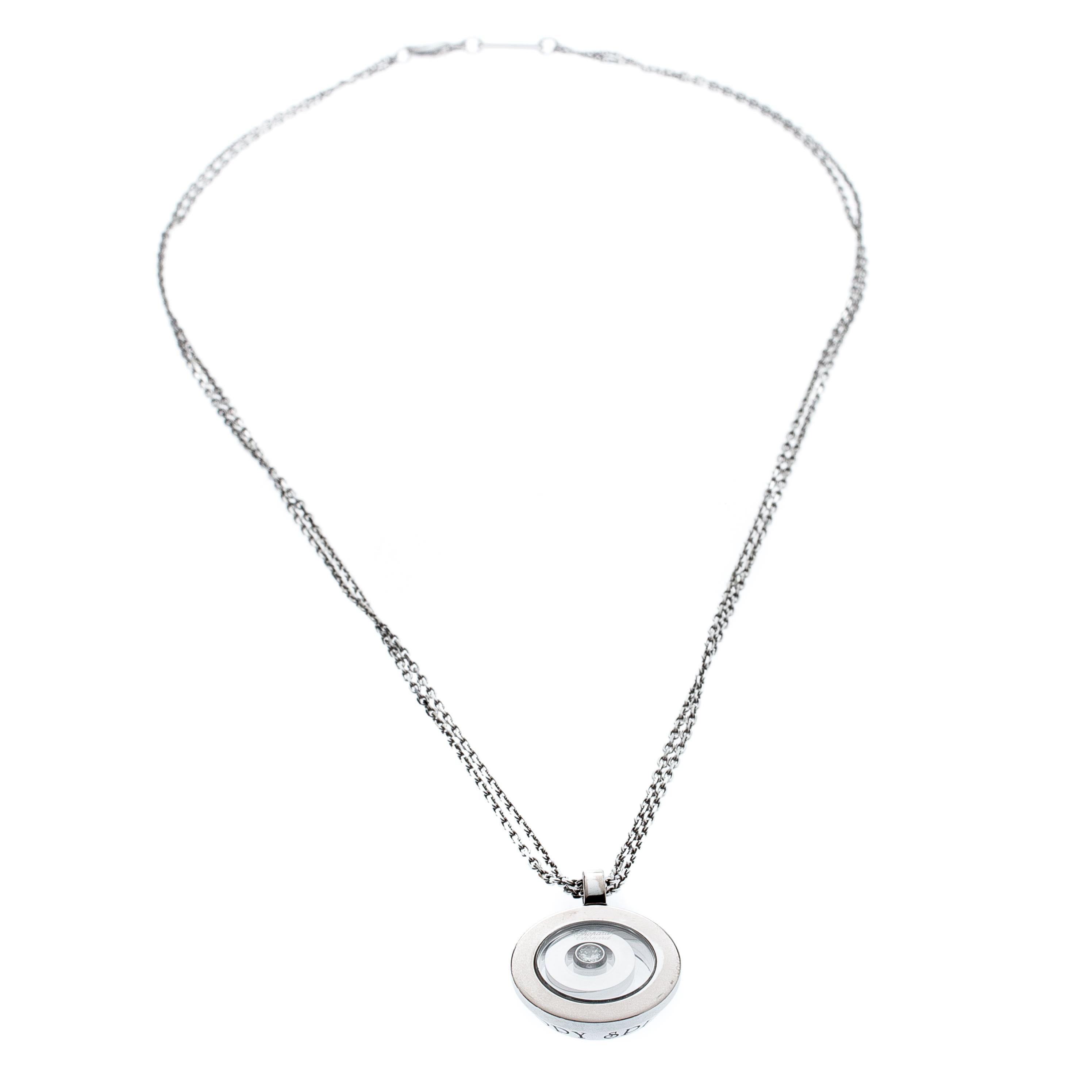 Unique and playful, this necklace from the Happy Spirit collection of Chopard is an elegant piece desirable by fashion-forward women. These are immaculately crafted in 18K white gold with a minimalist round pendant which embraces a small diamond