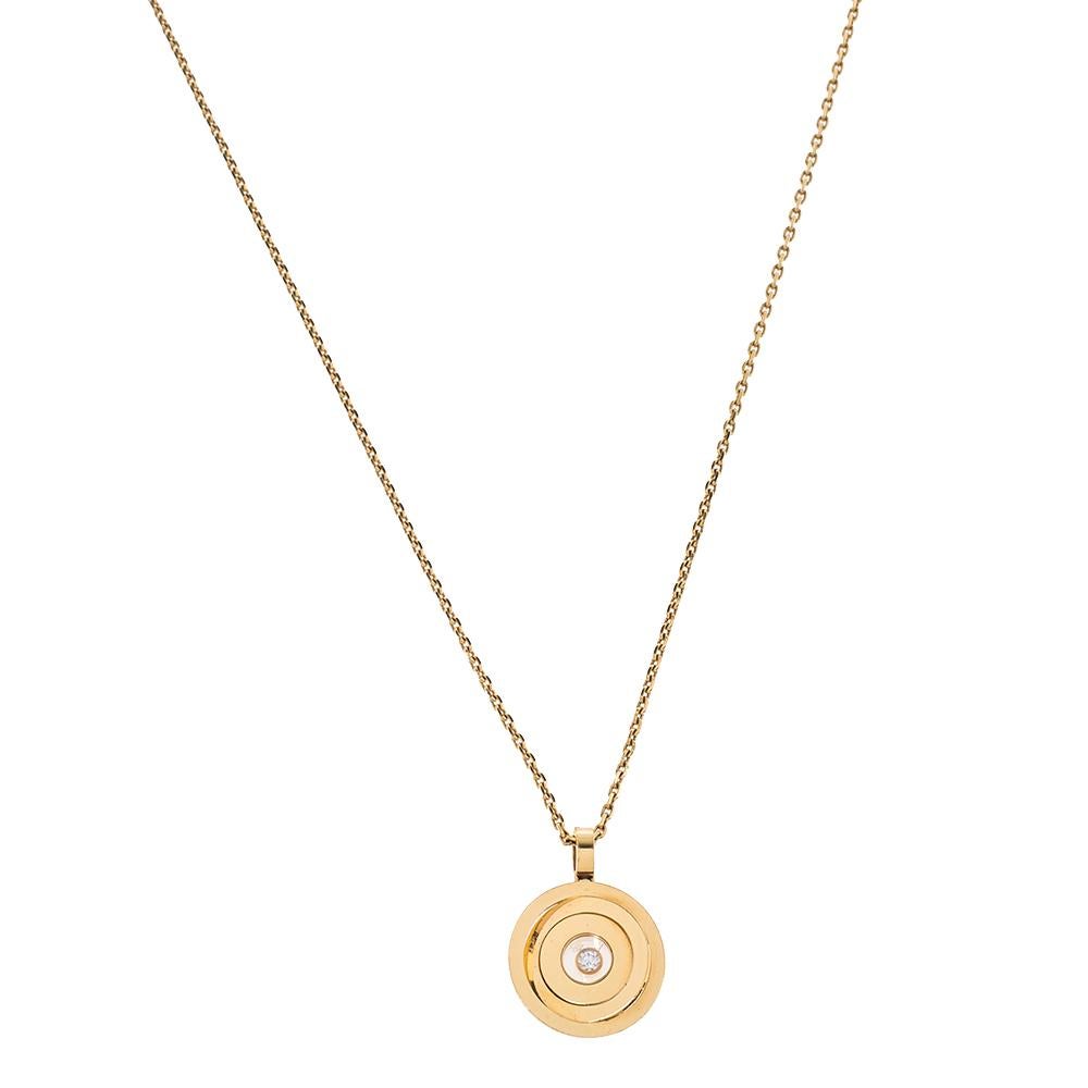 Chopard's Happy Spirit collection showcases this luminous necklace with a circular pendant. Fashioned in fine 18k yellow gold, this luxurious pendant features three circles that rest one inside the other while orbiting one floating diamond. This