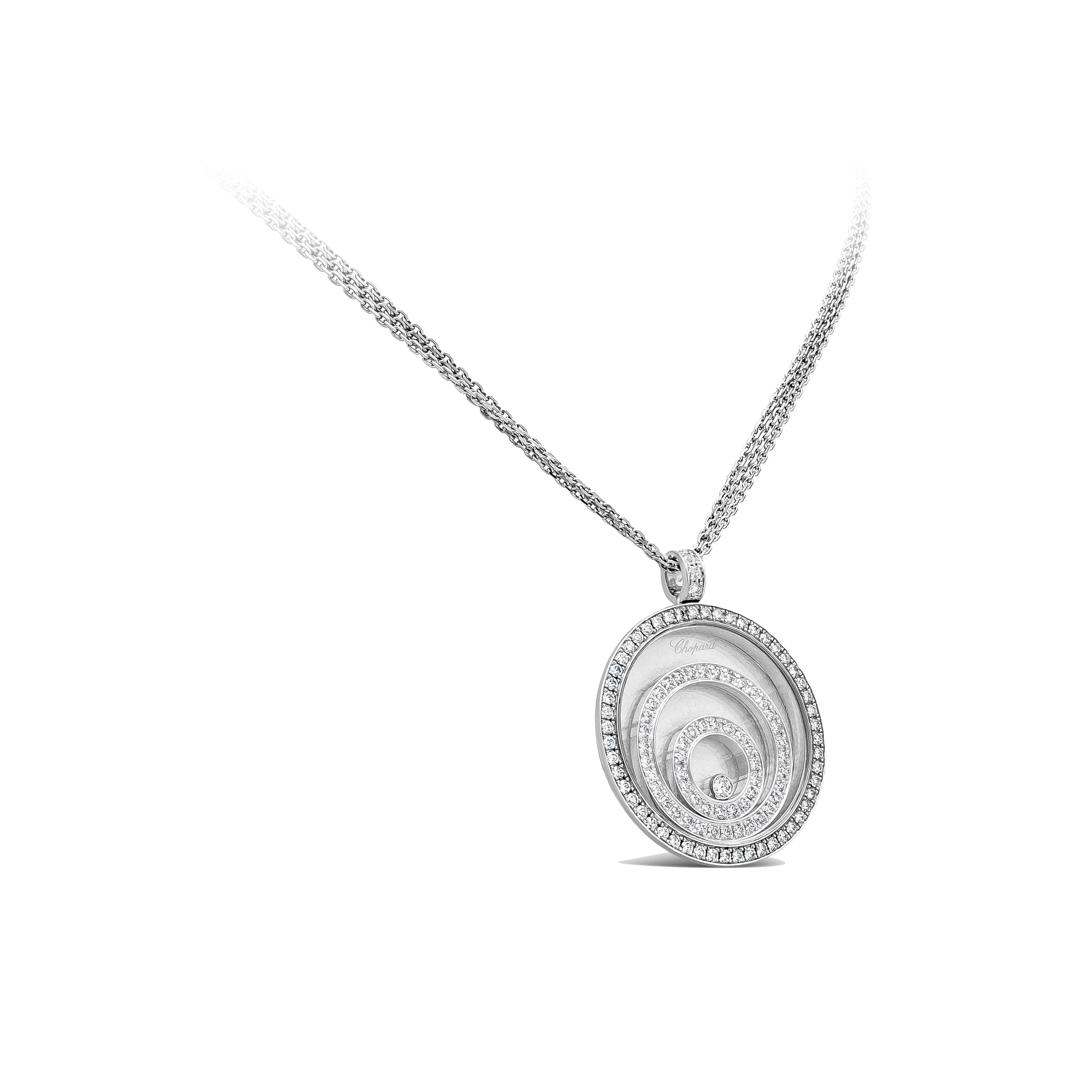 This gorgeous Chopard necklace is from the Happy Spirit Collection. The pendant is decorated with 2 concentric circles encased in the pendant and is set with brilliant round diamonds weighing 1.88 carats. A 0.10 carat round brilliant happy diamond