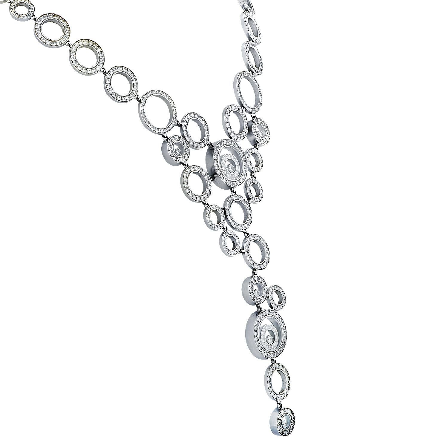 This mesmerizing diamond necklace from Chopard's iconic happy spirit collection, is crafted in 18 karat white gold, featuring 704 round brilliant cut diamonds, weighing approximately 10.88 carats, F color, VS clarity. With a joyful design of solid
