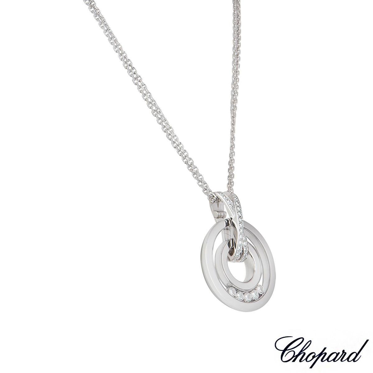An 18k white gold pendant from the Happy Spirit collection by Chopard. The circular pendant has a glass front encasing 5 round brilliant cut diamonds and also has a crossover diamond set bale. There are 33 diamonds in total with a weight of 0.53ct,