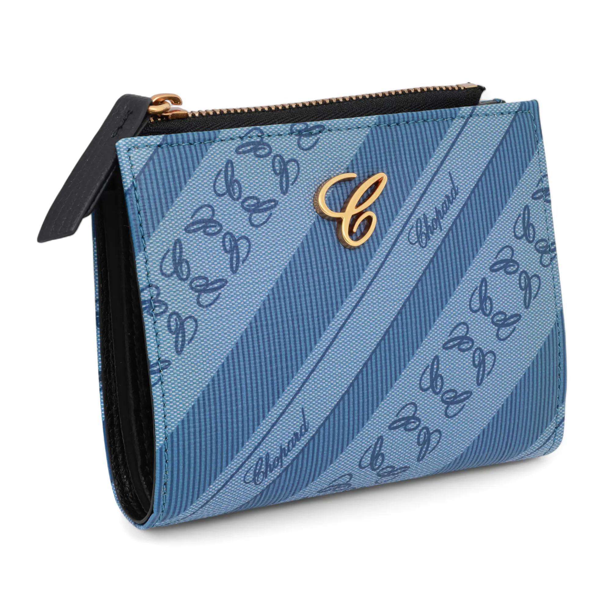 Chopard Happy Sport ladies medium size wallet crafted in blue logo print canvas. This super compact wallet features 6 card slots and a bill compartment with zipper coin pocket. It measures 5 x 4 x 1 inches. New without tags. Original box and dust