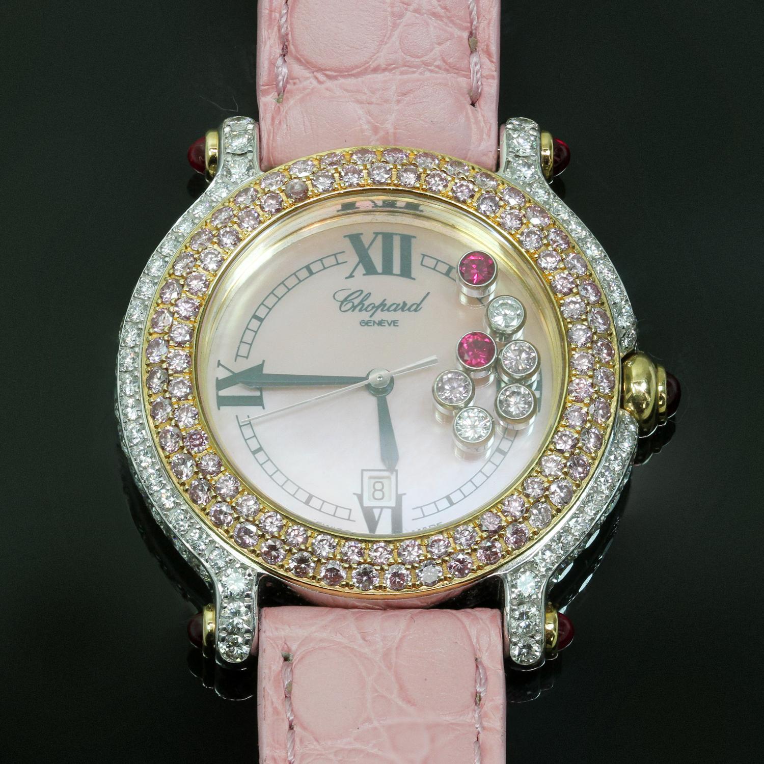 This exquisite women's wristwatch from Chopard's iconic Happy Sport collection features a white dial, Roman numeral hour markers, date display at 6 o’clock, 5 floating white diamonds and 2 floating pink sapphires, a 34mm 18k white & rose gold