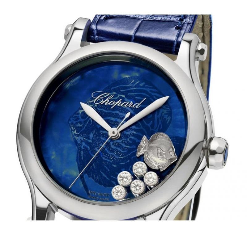 Watch Happy Sport 
SELF-WINDING MECHANICAL MOVEMENT
DIAL: BLUE MOTHER-OF-PEARL
 1 SAPPHIRE = 0.17 CT (BLUE) (CROWN)
5 DIAMONDS = 0.24 CT FC (MOVING)
1 MOVING FISH
POWER RESERVE OF APPROXIMATELY 42 HOURS, TWENTY-FIVE (25) JEWELS, CENTRAL SECOND,