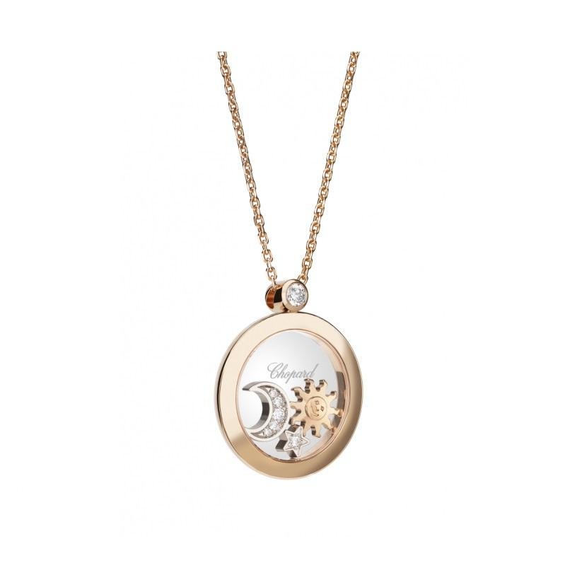 Adorned with fascinating astral moving elements, the Happy Diamonds pendant reveals a diamond-set 18K white gold dancing star and moon along with an 18K rose gold sun whirling between two sapphire glass and an 18K rose gold envelope.
1 DIAM. = 0,10