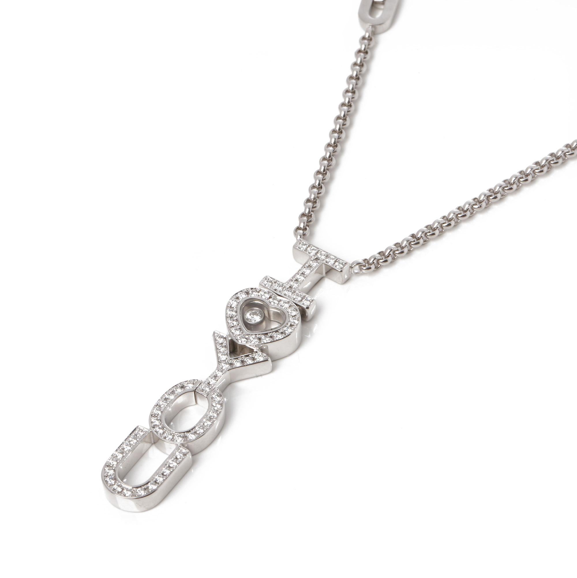 This pendant by Chopard is presented with a rolo chain that features two 