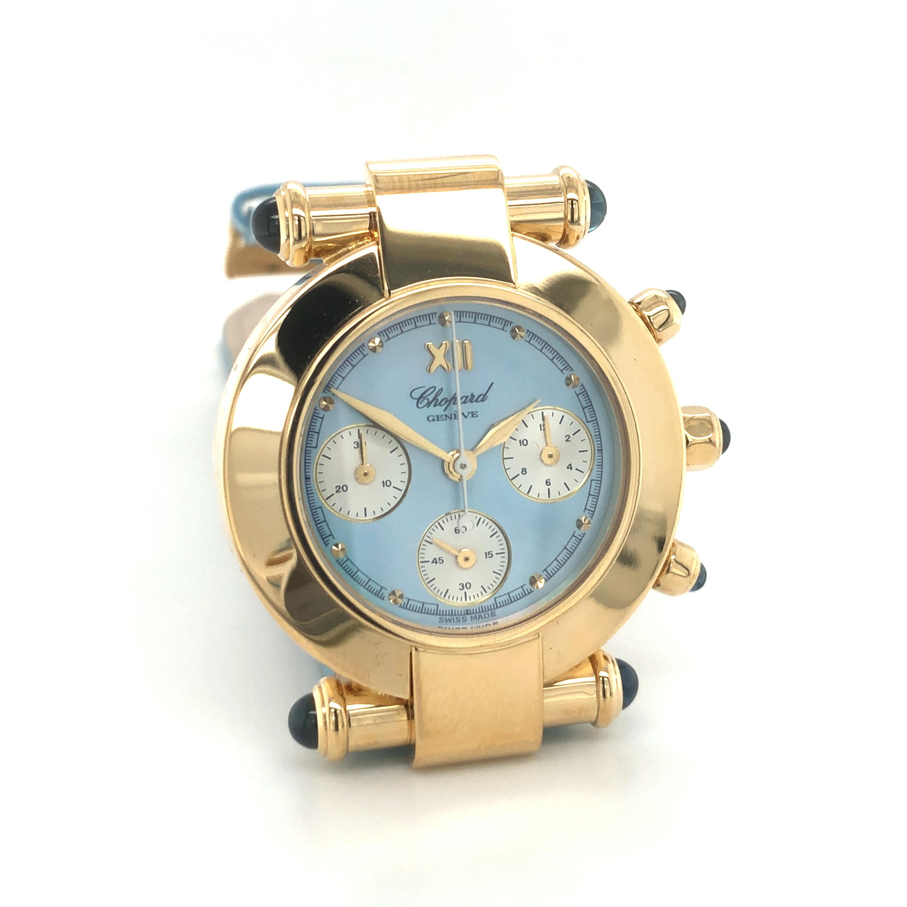 Attractive Chopard ladies watch in 18K yellow gold. Timeless Imperiale design with chronograph functions (seconds, minutes and hours indications). Lugs and pushers decorated with blue sapphire cabochons. 

Blue mother of pearl dial with golden