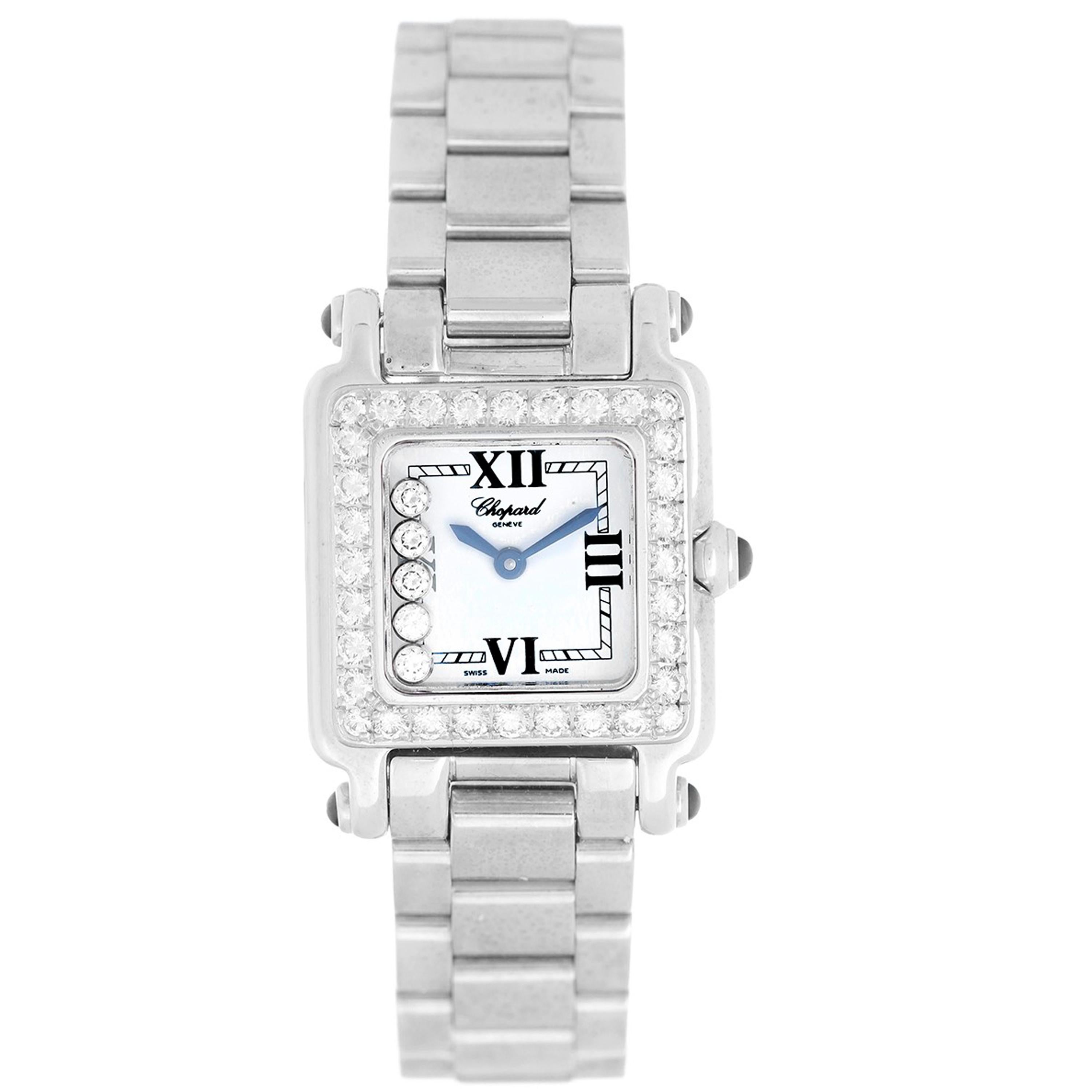 Quartz. 18k white gold case (28mm x 31mm). White dial with black Roman numerals and 5 floating diamonds. 18k white gold bracelet. Will fit approx 6 1/2 in wrist.  Pre-owned with Chopard box and papers.

Ref 27/6851-23/11