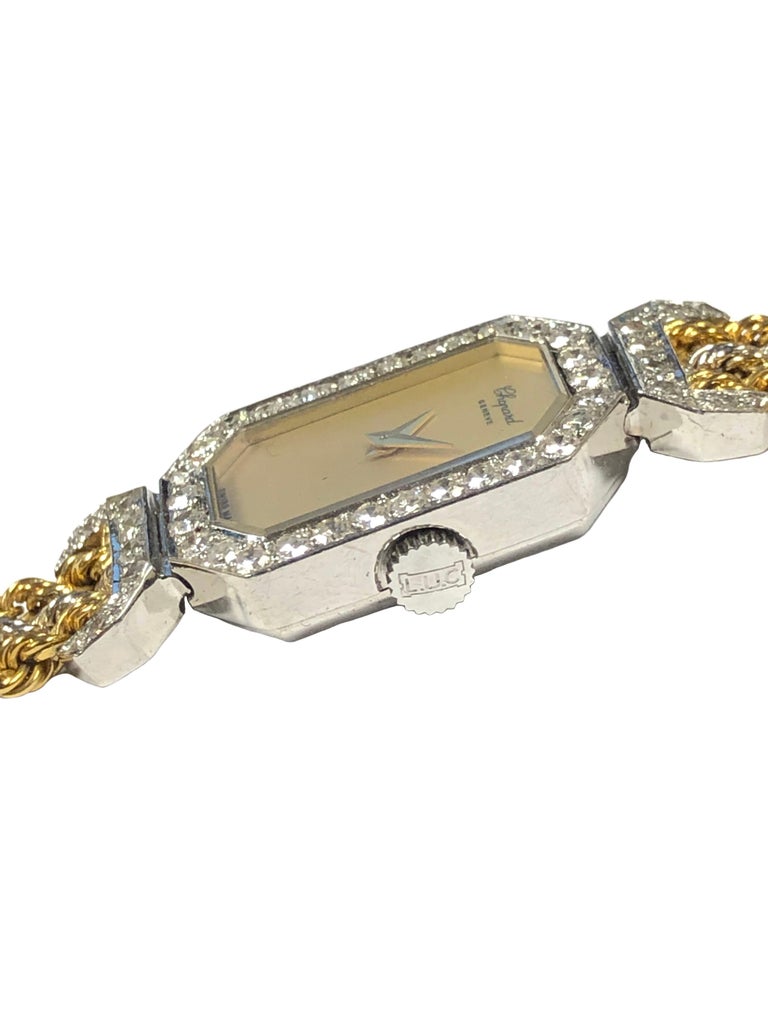 Circa 2000 Chopard Ladies Wrist Watch, 22 X 15 M.M. 18K White Gold 2 piece case with flexible lugs, both the Lug tops and the Bezel are set with round Brilliant cut Diamonds totaling 1 Carat. 17 Jewel Mechanical, Manual wind movement, Champaign face
