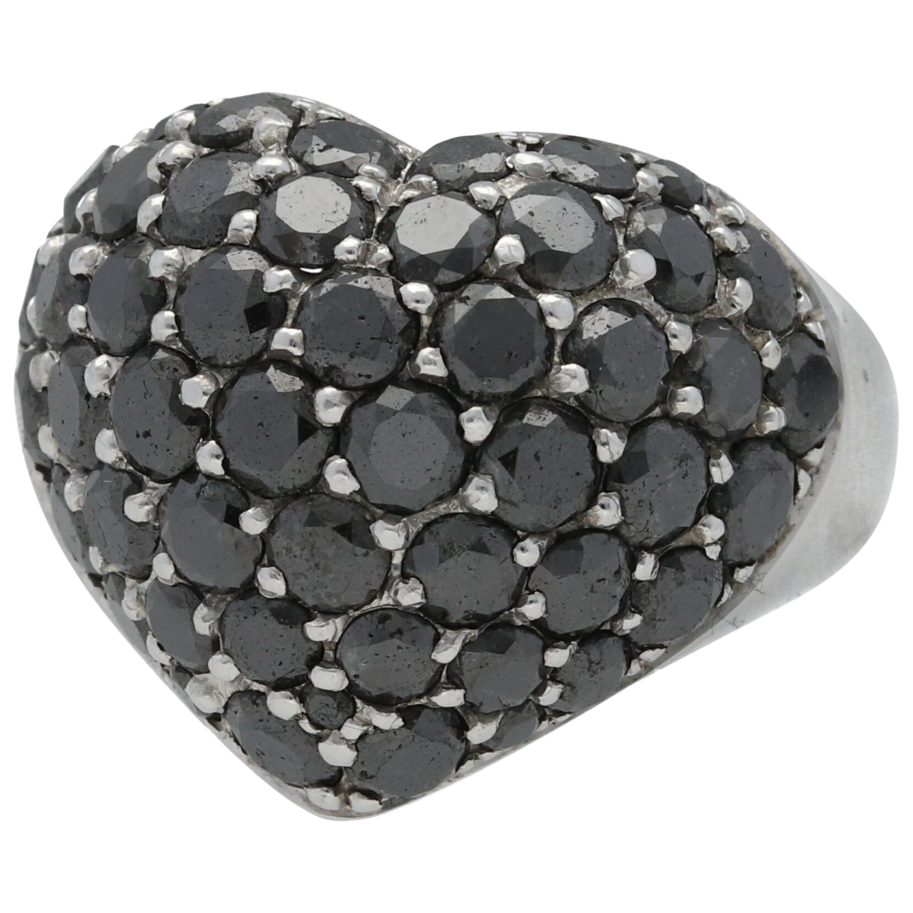 A Chopard cocktail ring, set with 49 circular-cut black diamonds, weighing 4.98 carats, mounted in a heart shaped 18K white gold ring, weighing 11.6 grams, with the word LOVE inscription in the back.

Size US  6.5 - 53.1 mm

Components:
Total  black