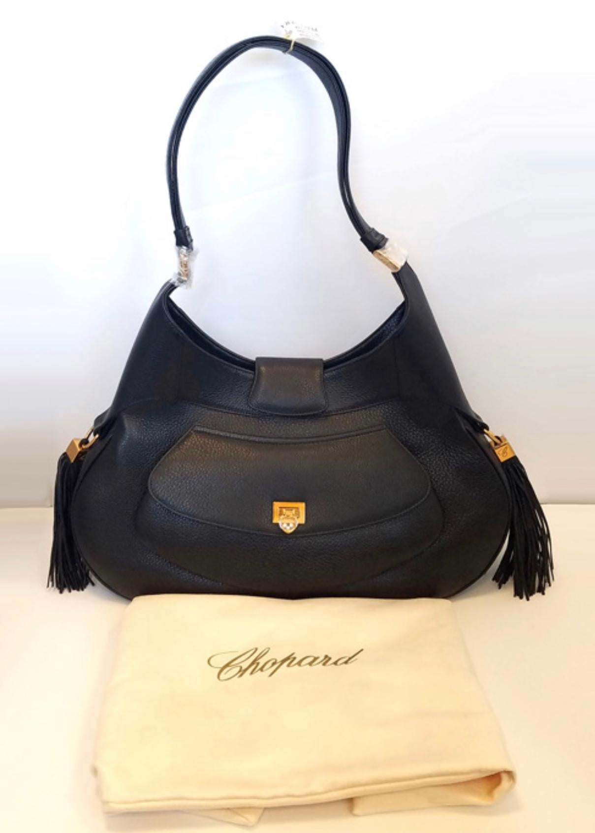 This handbag from Chopard has an earthy yet glamorous feel that is perfect for every day wear. Made in Italy of the finest calfskin leather and a gorgeously patterned cloth, this bag will stay in good shape for many years to come. With dimensions