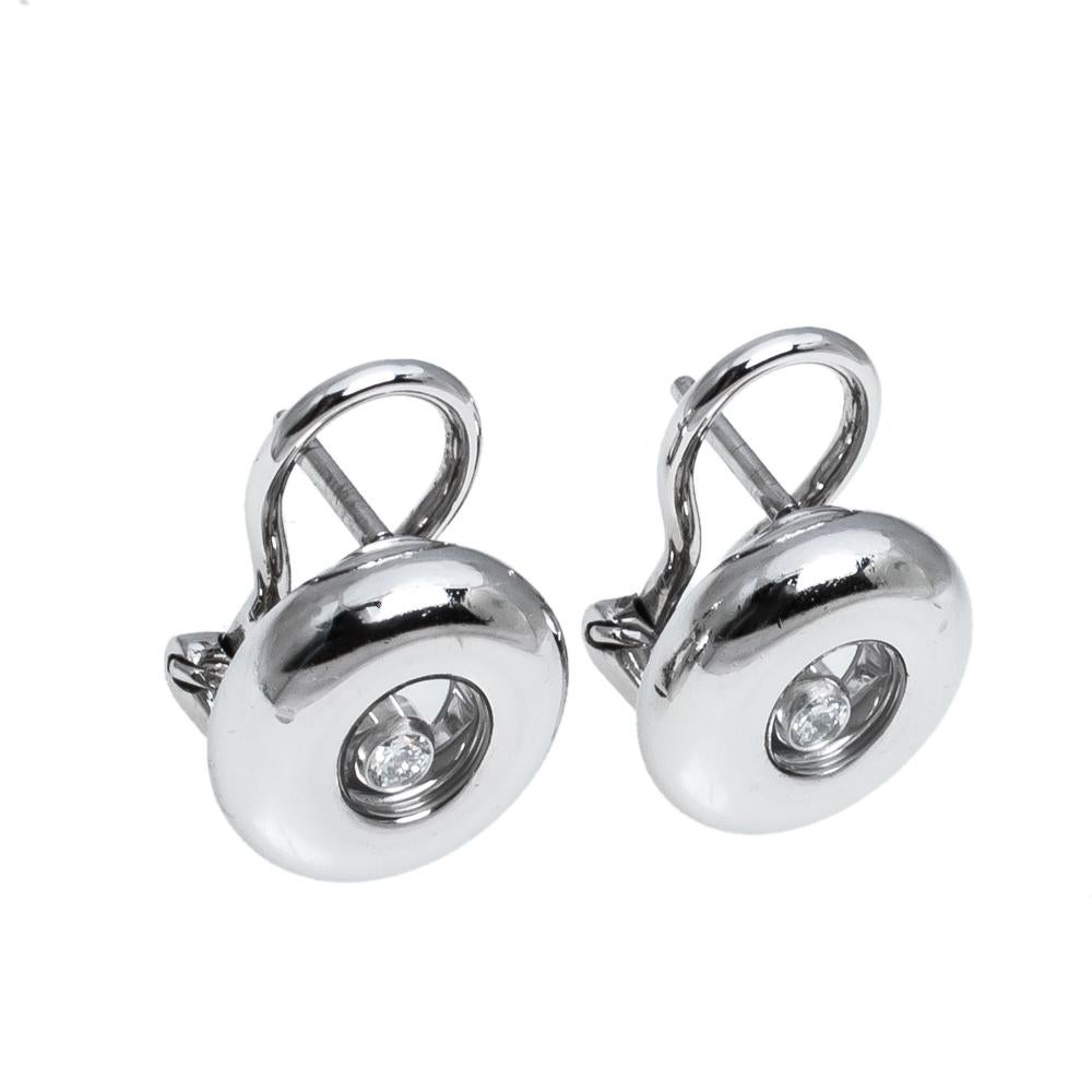 These precious earrings from Chopard tug at one's heartstrings in the sweetest way. Sculpted from 18k white gold and designed with a single diamond trapped within each stud, the pair is lovely. Be sure to try them with swept hair and a matching