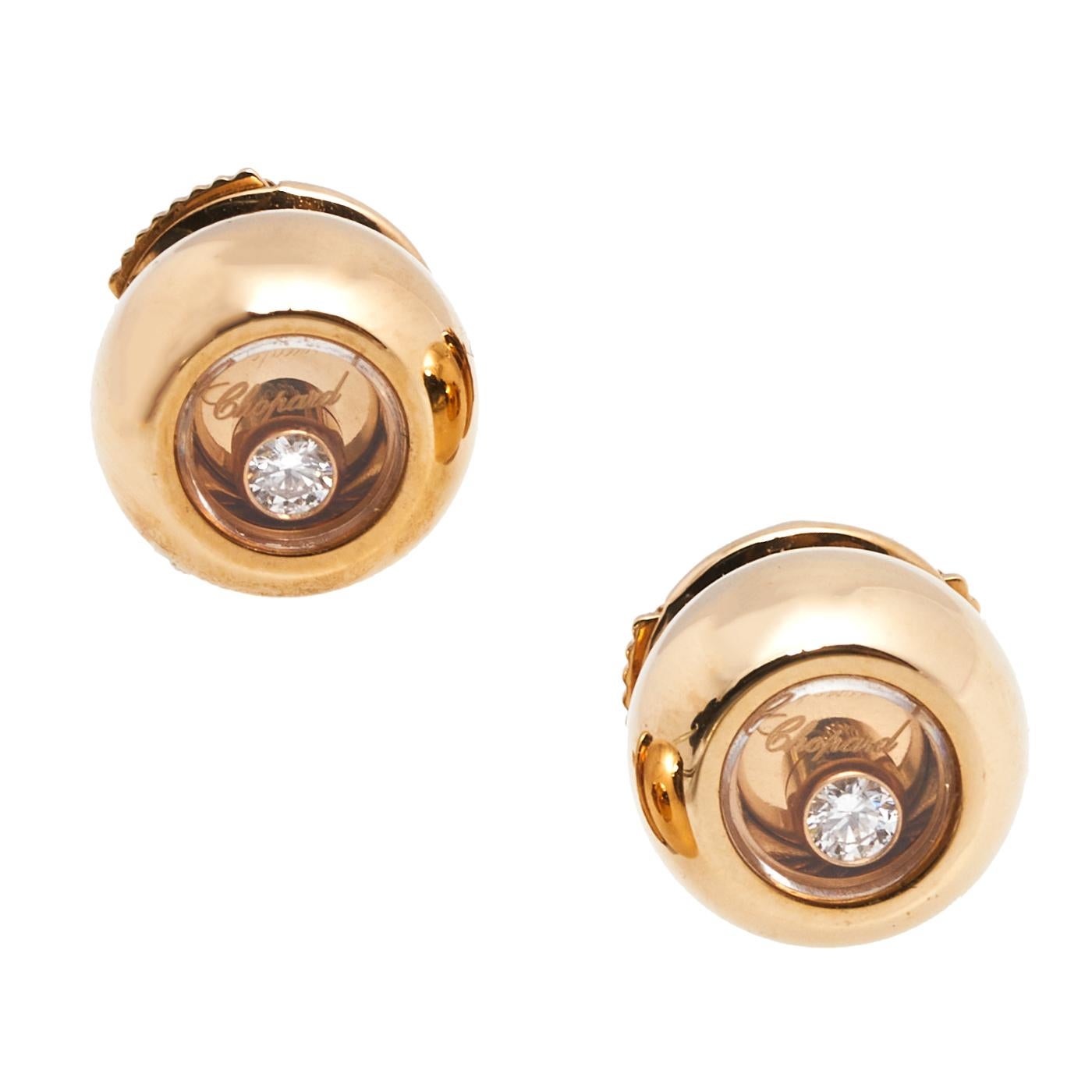 These precious earrings from Chopard tug at one's heartstrings in the sweetest way. Sculpted from 18k rose gold and designed with a single diamond trapped within each stud, the pair is lovely. Be sure to try them with swept hair and a matching