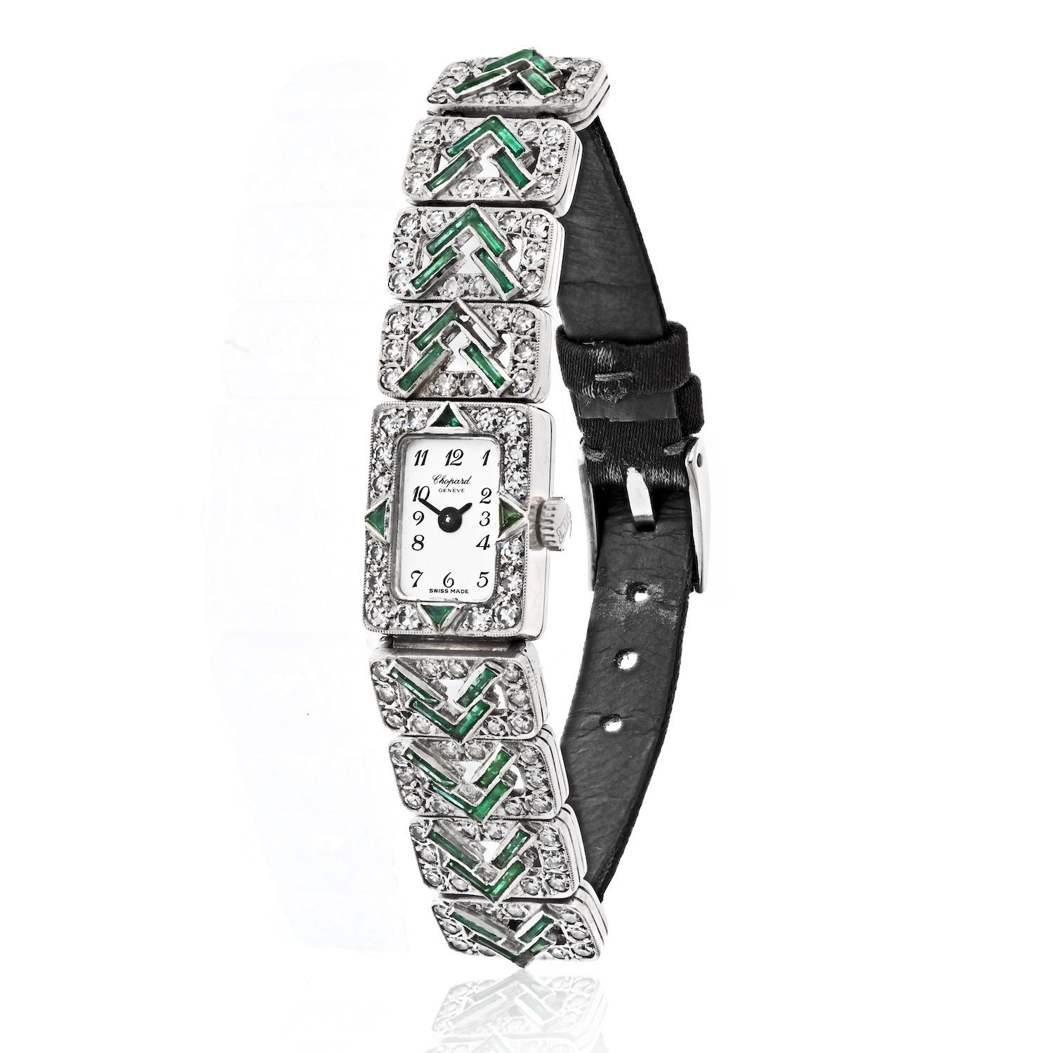 Embrace the elegance of a bygone era with this exquisite Art Deco Chopard Lady's Dress Watch, meticulously crafted from 18K white gold. This timeless piece is adorned with sparkling diamonds and vibrant emeralds on both the case and lugs, showcasing