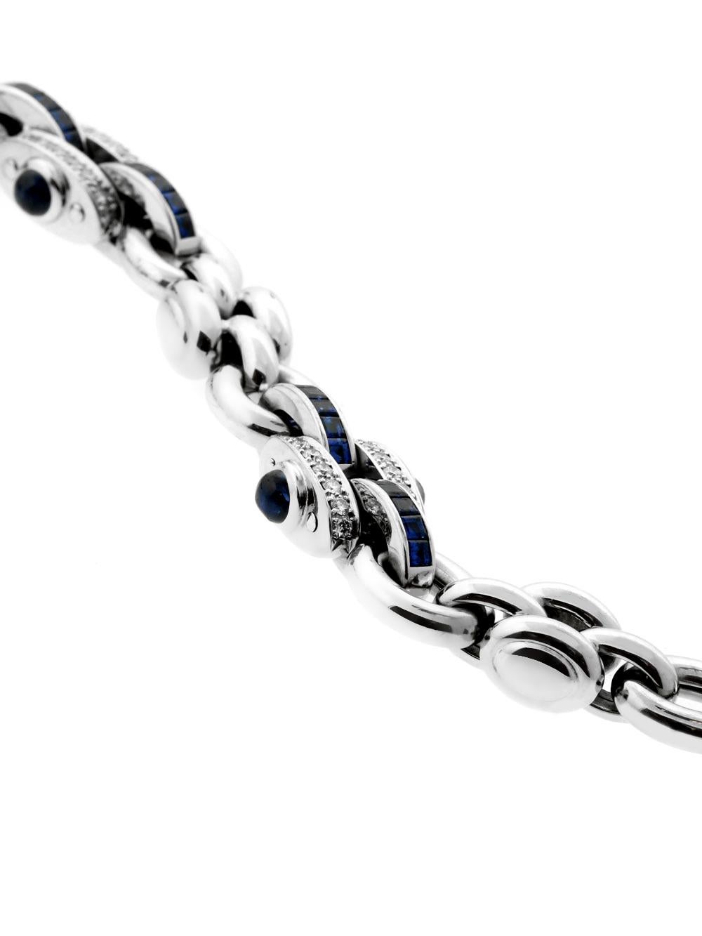 A luxurious authentic Chopard link style bracelet featuring rich blue sapphires and round brilliant cut diamonds set in 18k white gold measuring 7 1/2