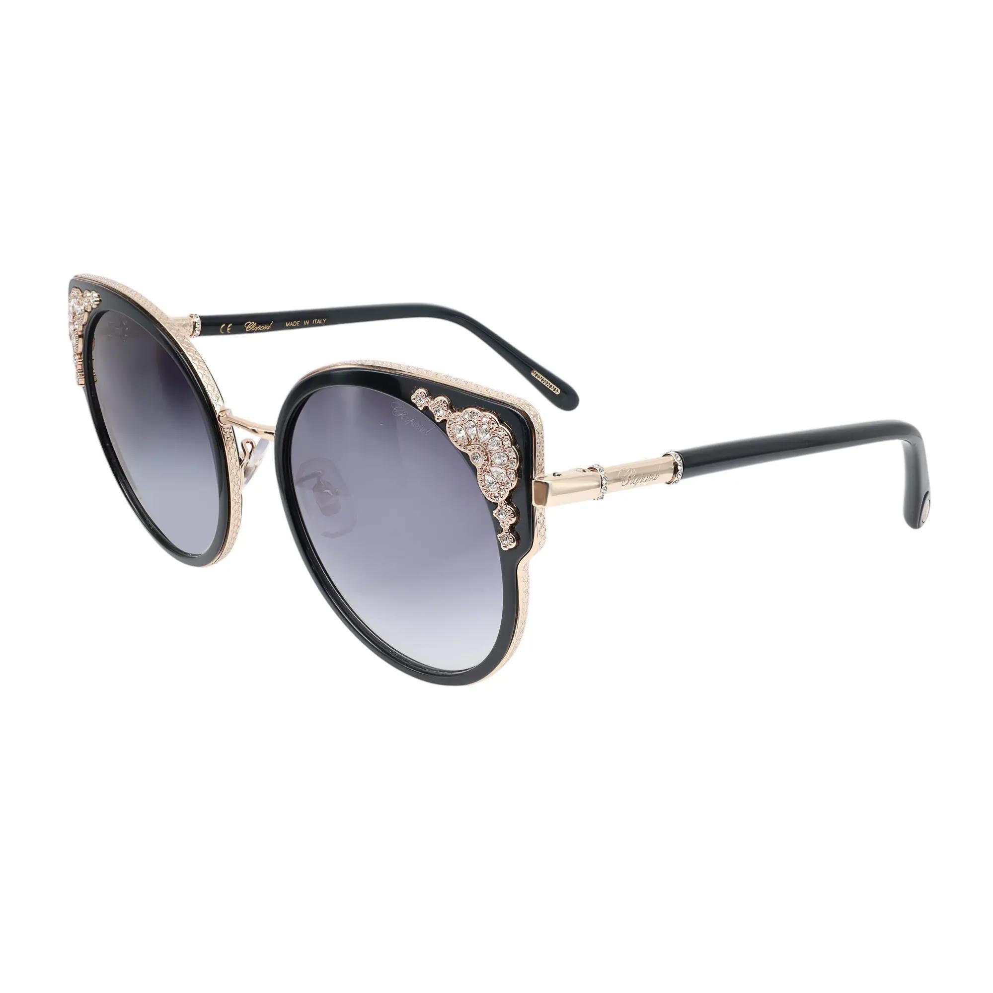 Presenting the luxury unisex Chopard Sunglasses 95221-0442, ideal for street fashion. These sunglasses feature a shiny rose gold metal/injected frame with strass and orange with smoke gradient lenses. The arms are adorned with the Chopard logo. The