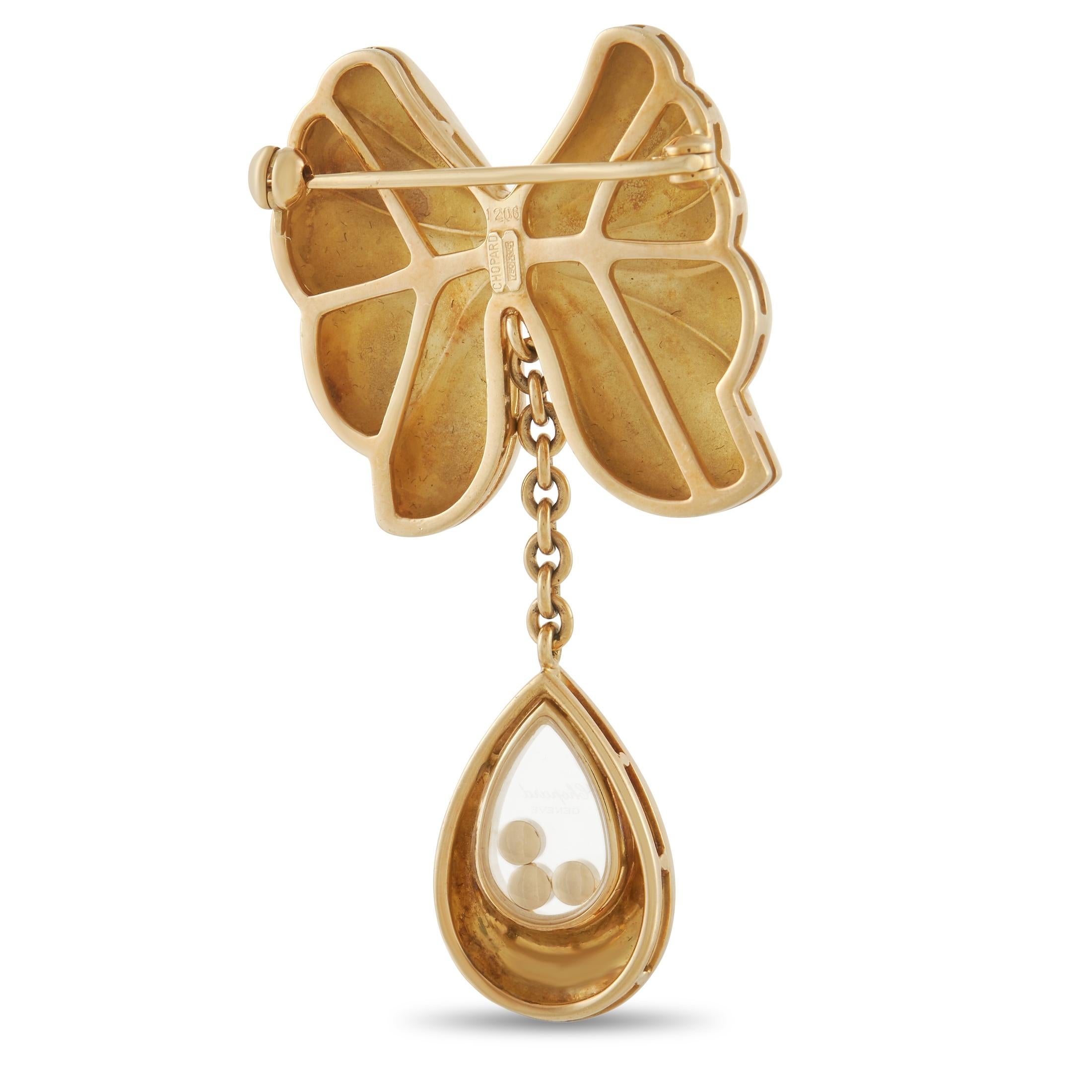 This Vintage Chopard Happy Diamond Brooch is a luxury piece with a certain sense of whimsy. The perfect addition to any jacket lapel, hat, or collar, it features a stunning 18K Yellow Gold bow. Suspended below, you’ll find a transparent