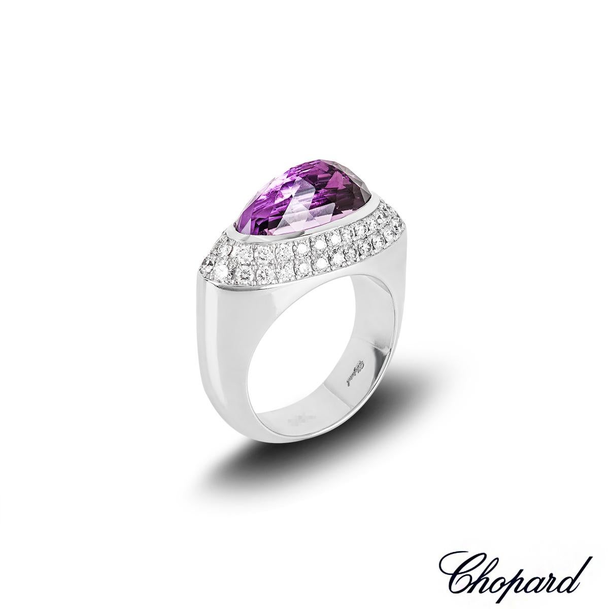 A lovely 18k white gold amethyst and diamond ring by Chopard. The ring features a rose cut amethyst set east-west to the centre in a bezel setting, measuring 15mm in width and 7mm in height. The amethyst is complemented by 50 round brilliant cut