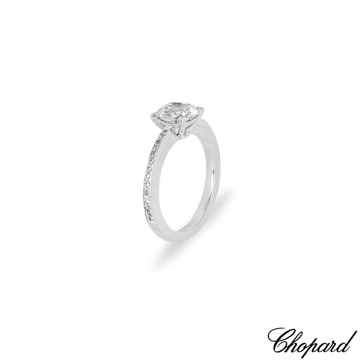 A stunning 18k white gold diamond ring by Chopard. The ring is set to the centre with a round brilliant cut diamond in a classic four claw mount, weighing 1.01ct, D colour and VS2 clarity. The centre diamond is further complemented by 26 round