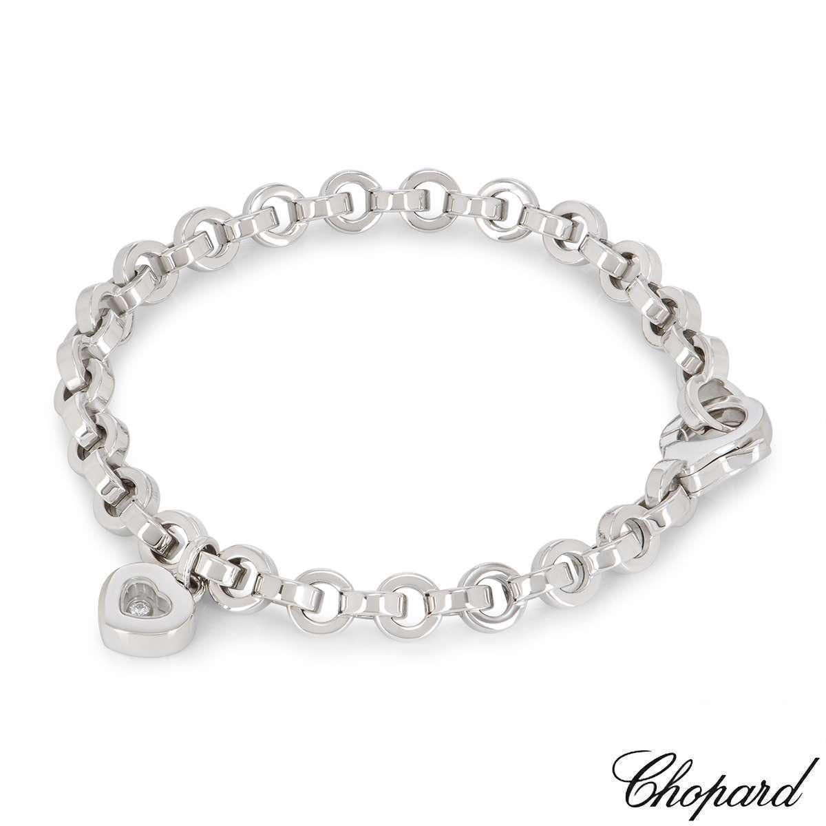 A stunning 18k white gold heart bracelet by Chopard from the Happy Diamonds collection. The necklace features a heart motif set with the iconic Chopard signed glass in the centre encasing a single floating diamond with an approximate weight of