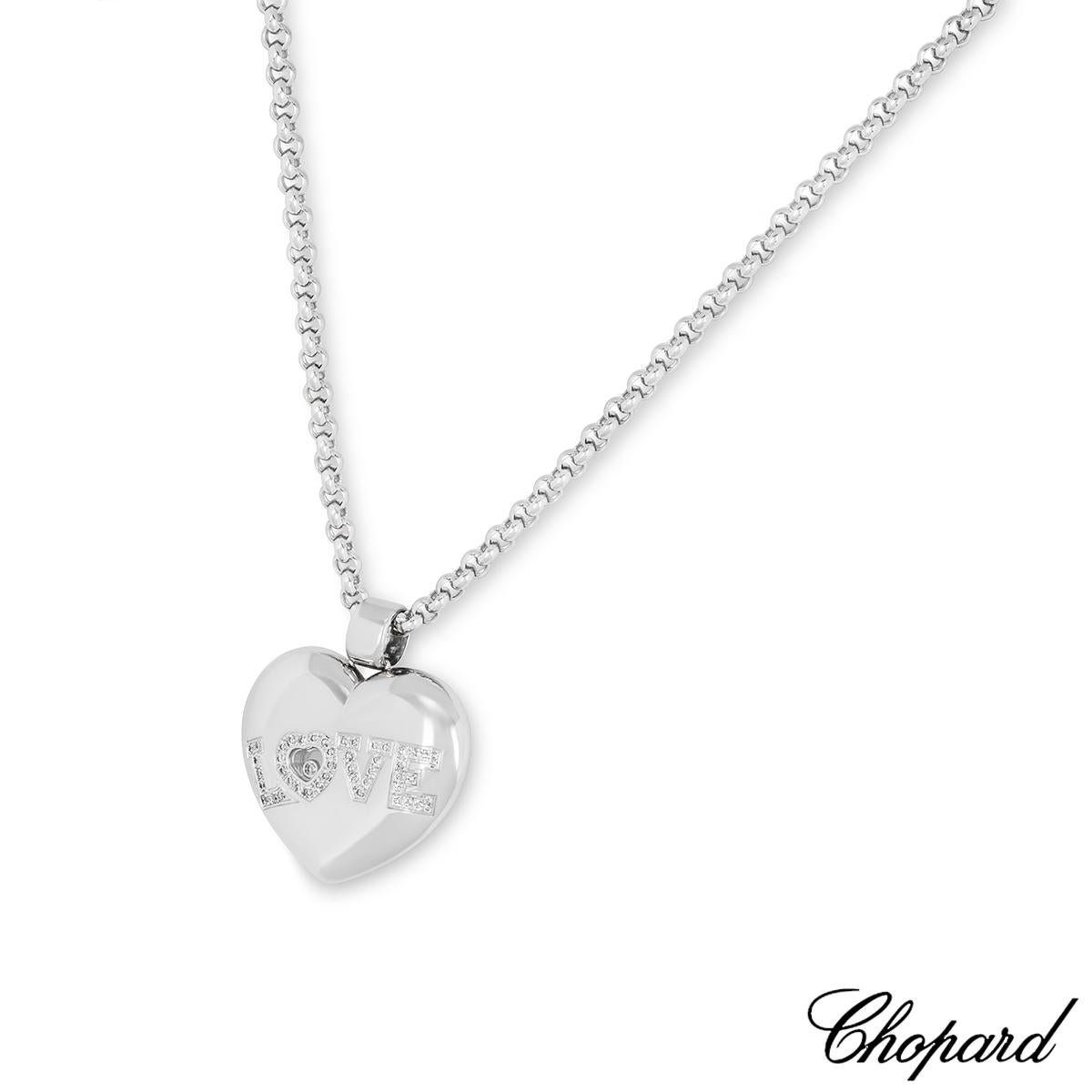 A beautiful Chopard 18k white gold diamond heart pendant from the Happy Diamonds collection. The heart pendant comprises of one floating round brilliant cut diamond encased behind the signature Chopard signed glass, weighing 0.05ct. Complemented