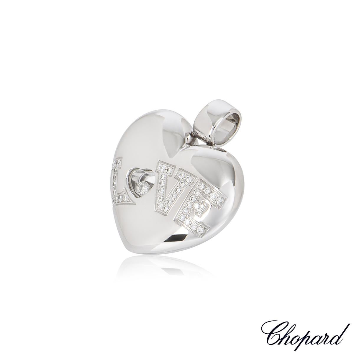 A beautiful Chopard 18k white gold diamond heart pendant from the Happy Diamonds collection. The heart pendant comprises of one floating round brilliant cut diamond encased behind the signature Chopard signed glass, weighing 0.04ct. Complemented