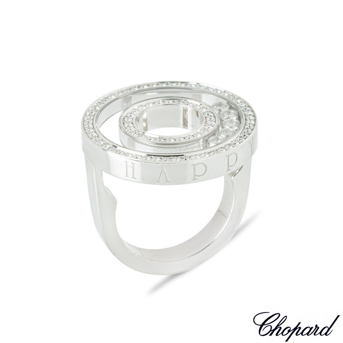 A beautiful 18k white gold diamond ring by Chopard from the Happy Diamonds collection. The openwork circular motif ring features 53 round brilliant cut diamonds set to the outer edge and 26 round brilliant cut diamonds pave set to the inner edge